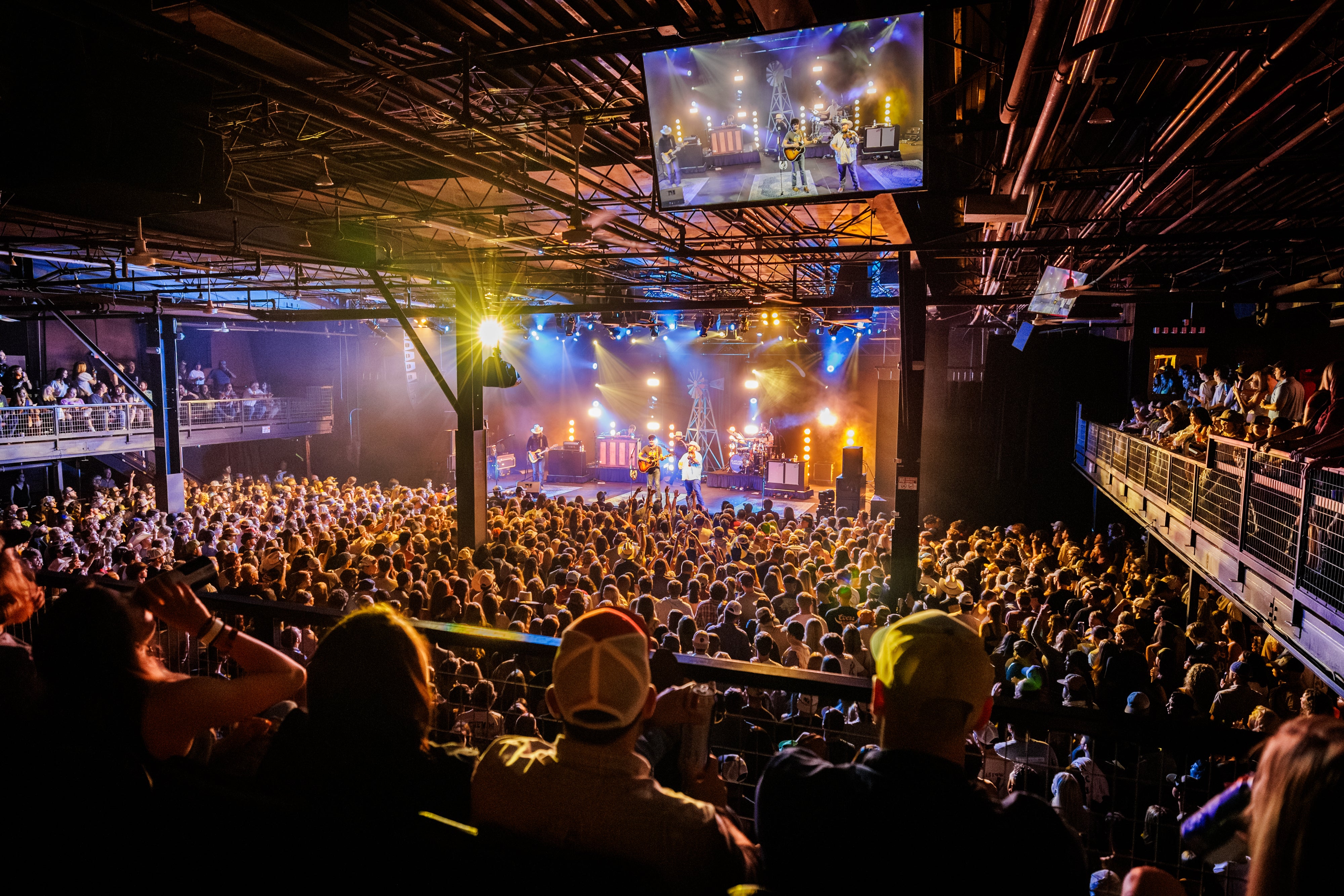 A concert with people watching a band on stage