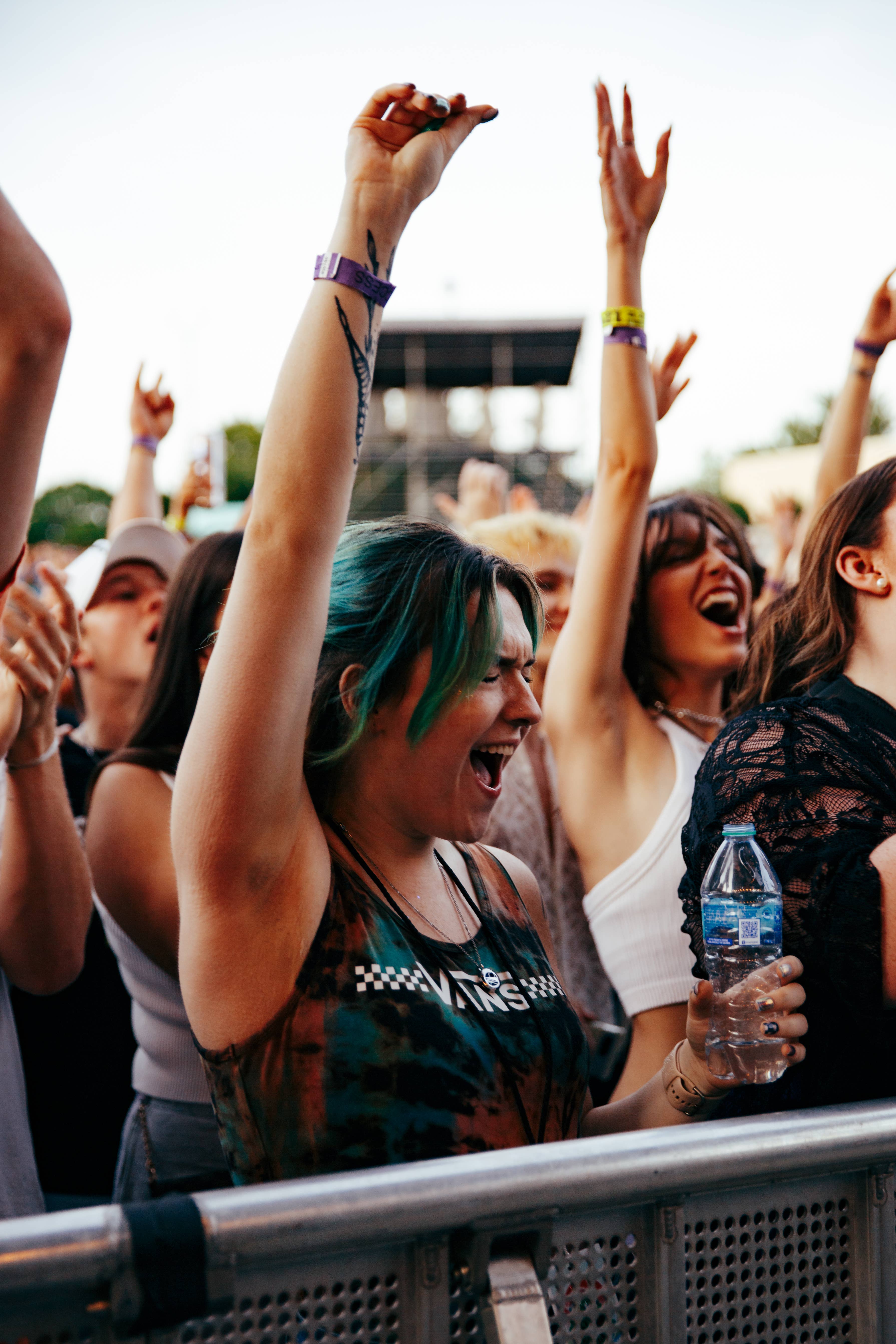 A women smiling with her eyes closed and hand up at the Briston Maroney concert at Skyla Credit Union Amphitheatre.