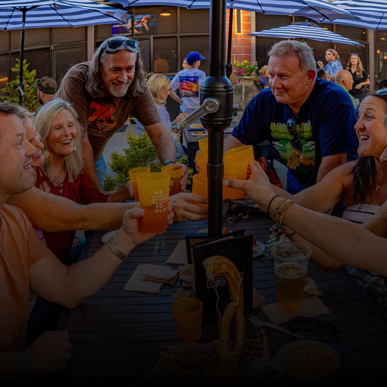Six friends in the lounge at a dining table with drinks
