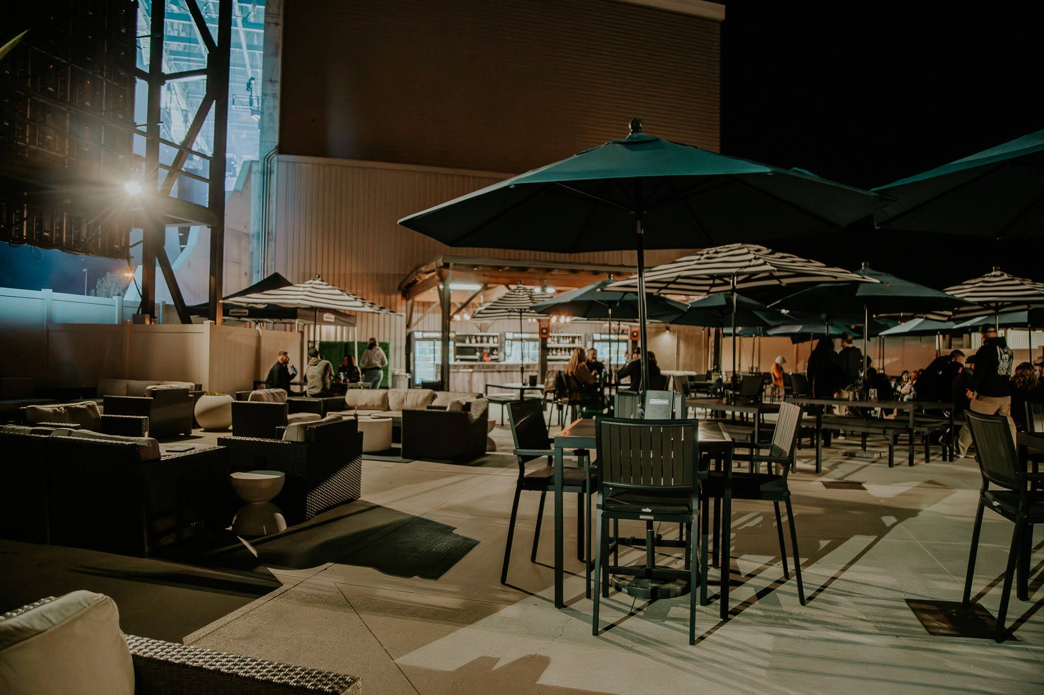 A photo of the club area with picnic tables and concessions in the background 