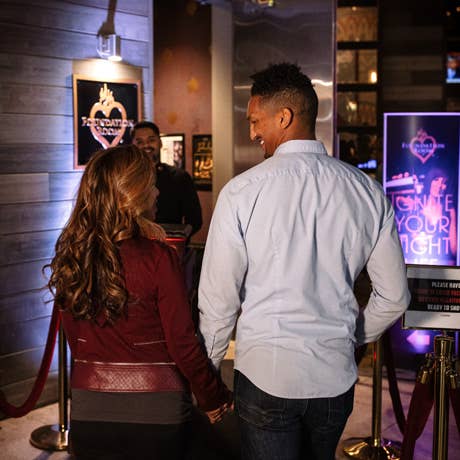 A couple walking through a lobby approaching the Foundation Room entrance
