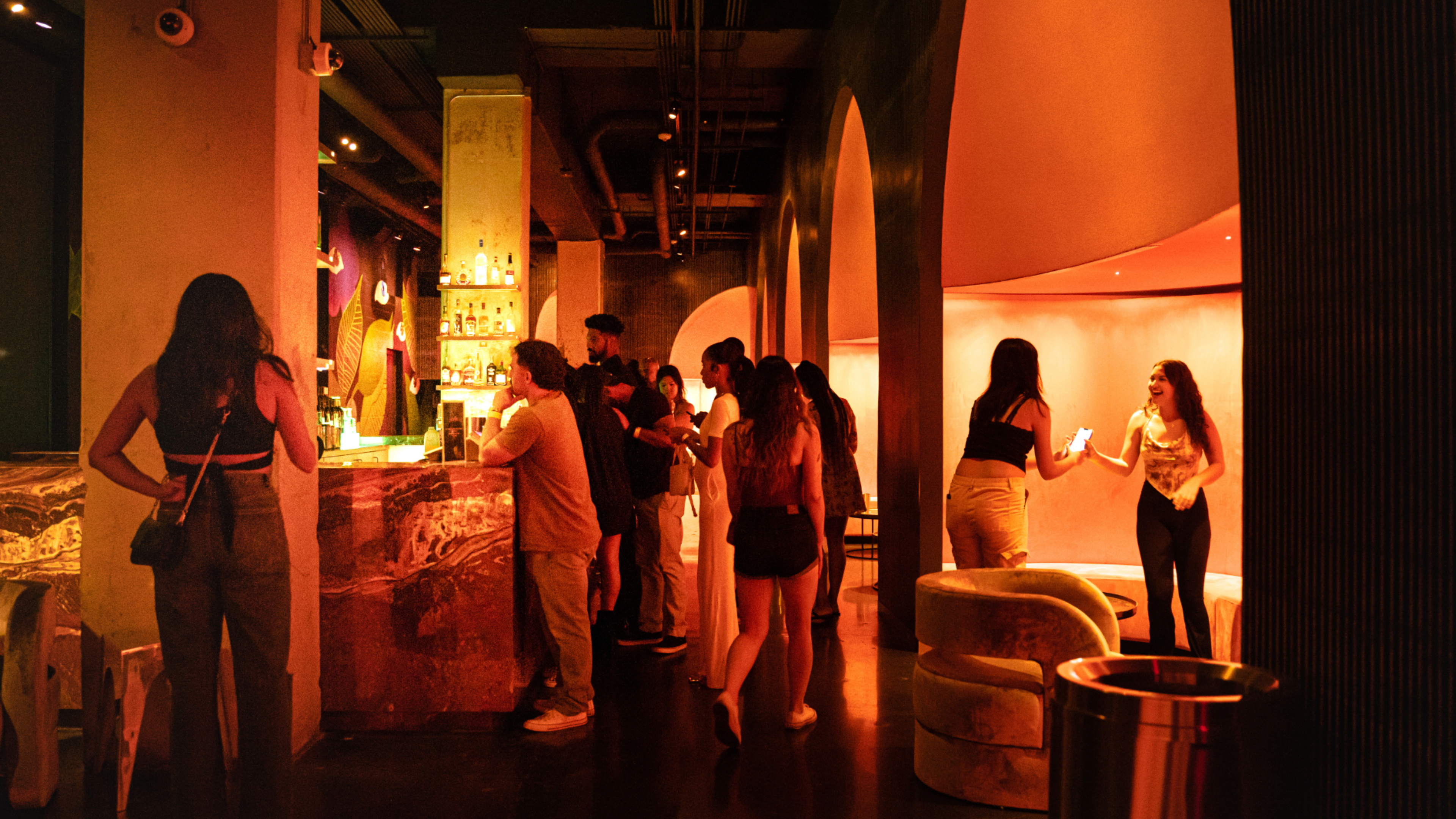 A few people standing in a lounge area