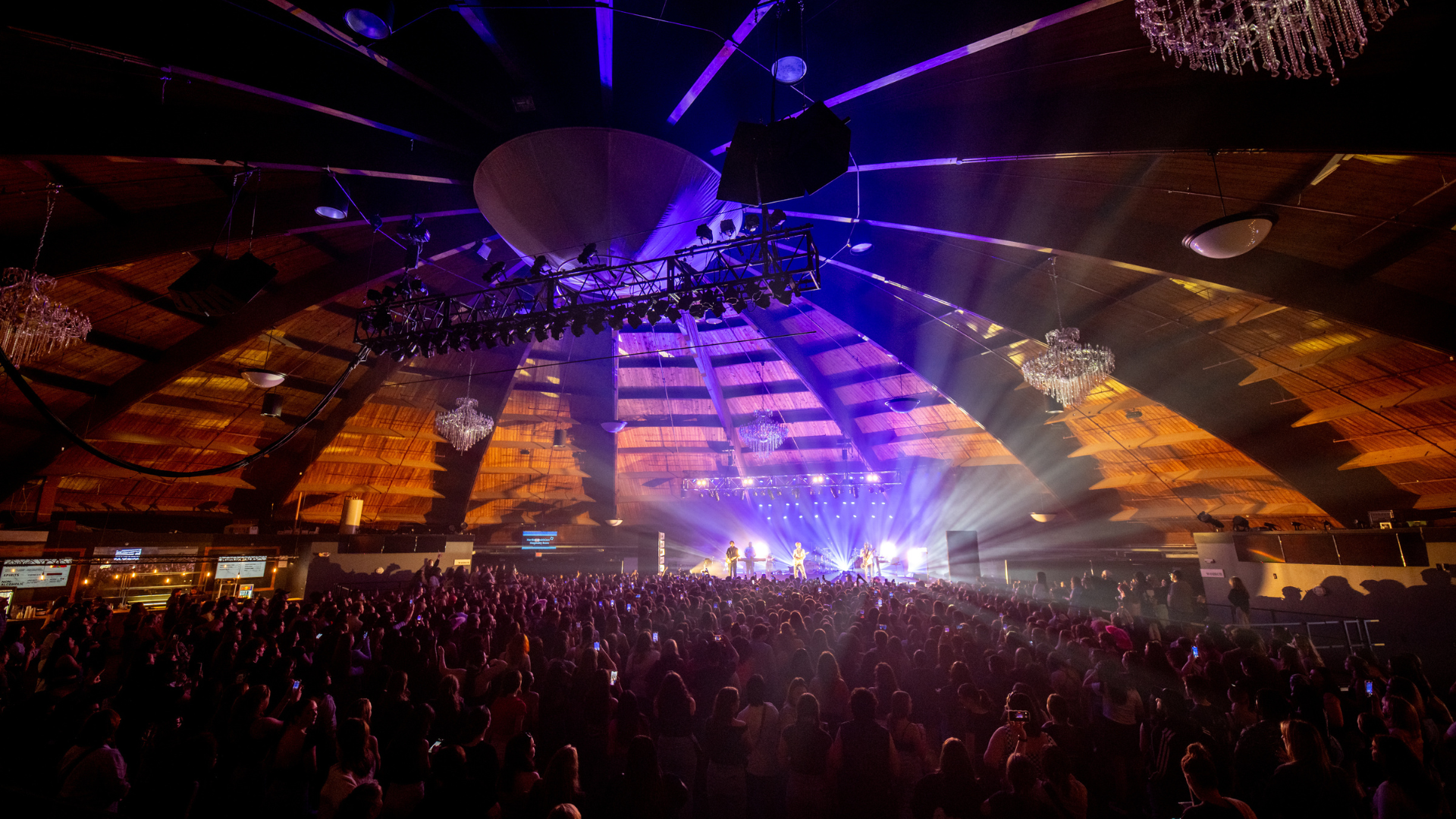 A room full of fans with a small stage