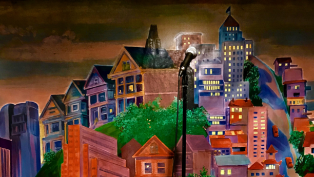 A microphone in front of Punch Line San Francisco's stage backdrop.