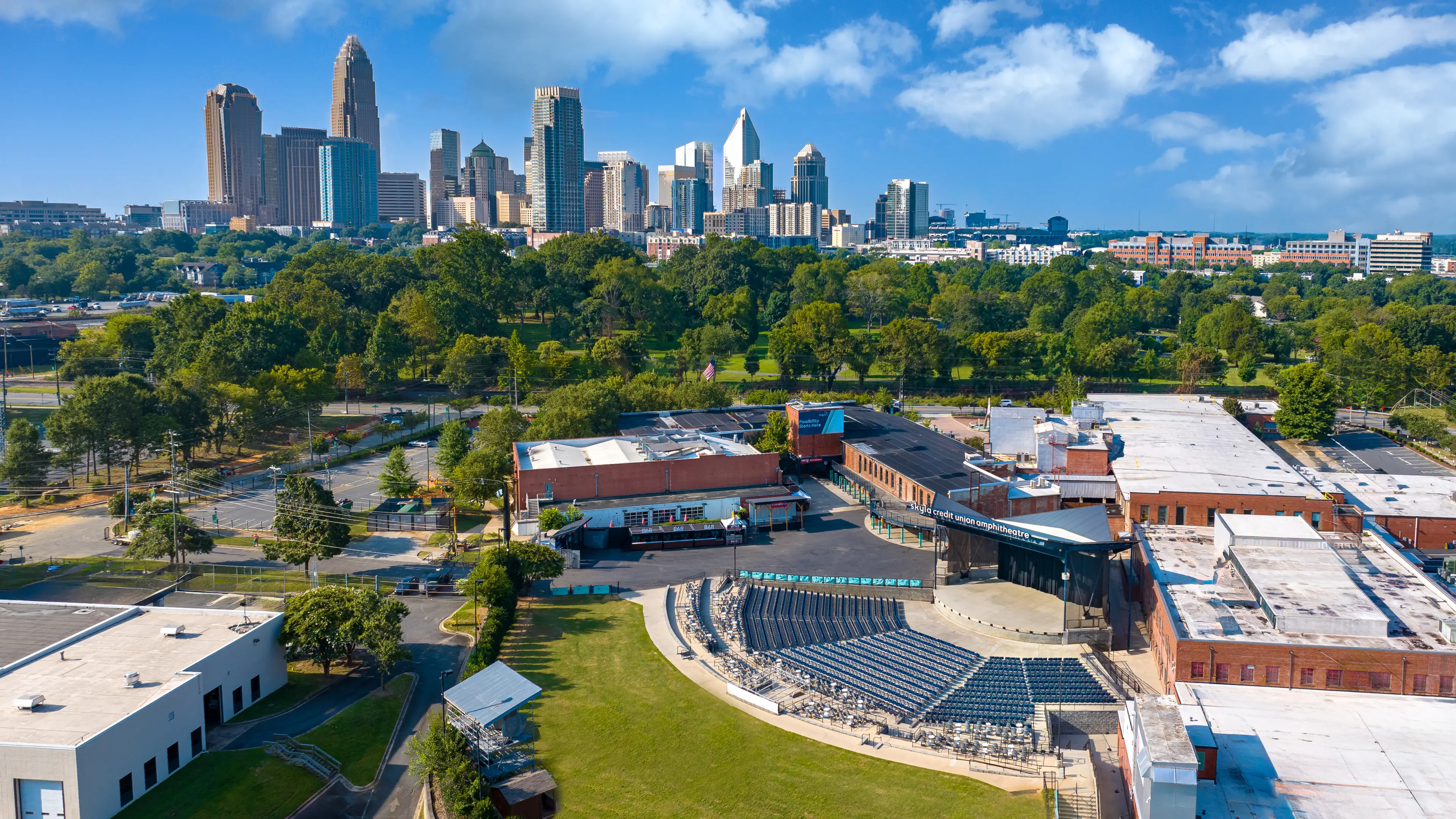 A wide aerial shot of Skyla Credit Union Amphitheatre with the Charlotte, North Carolina skyline. 
