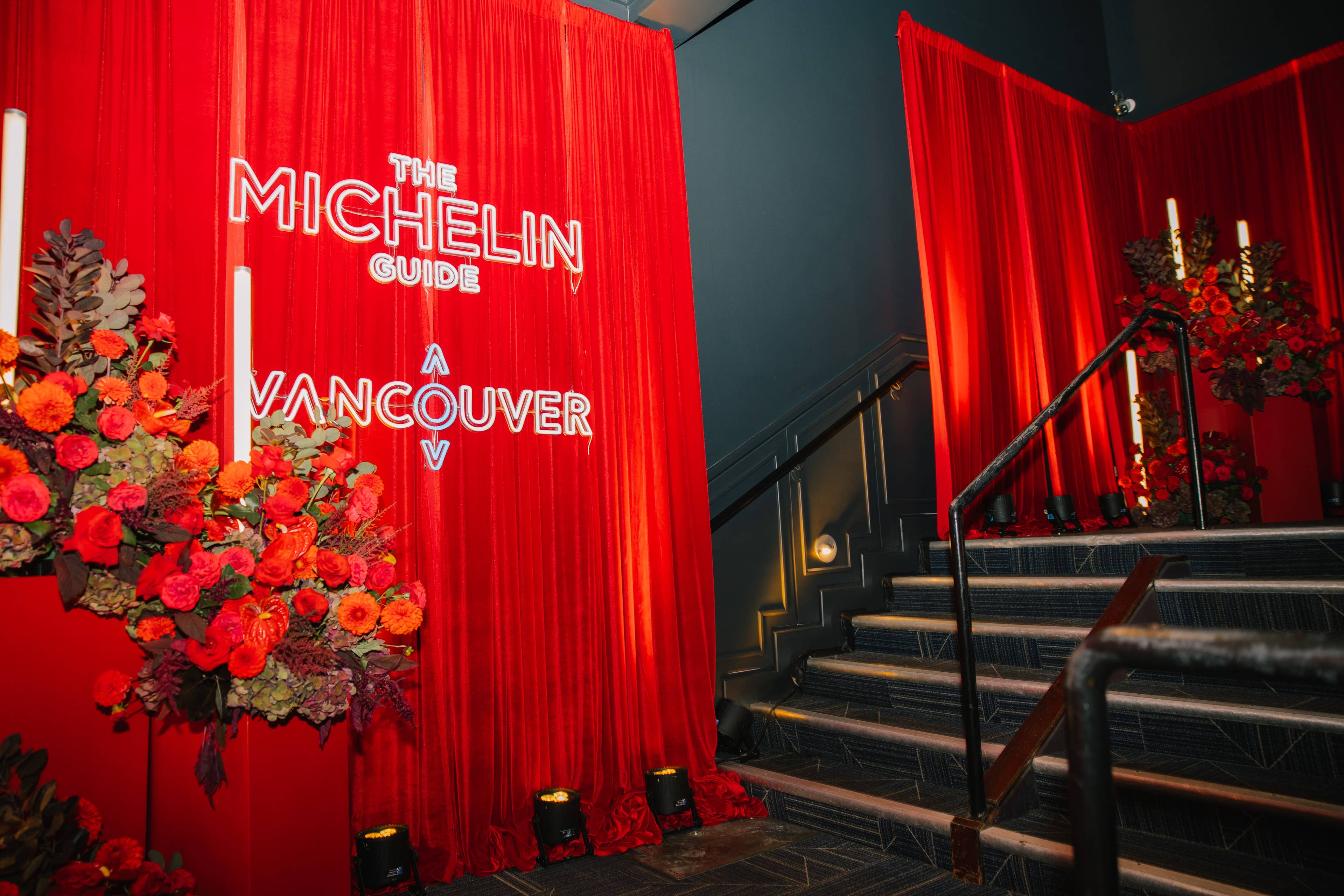 view of red curtains and flowers and the words "the michelin guide" on the curtain