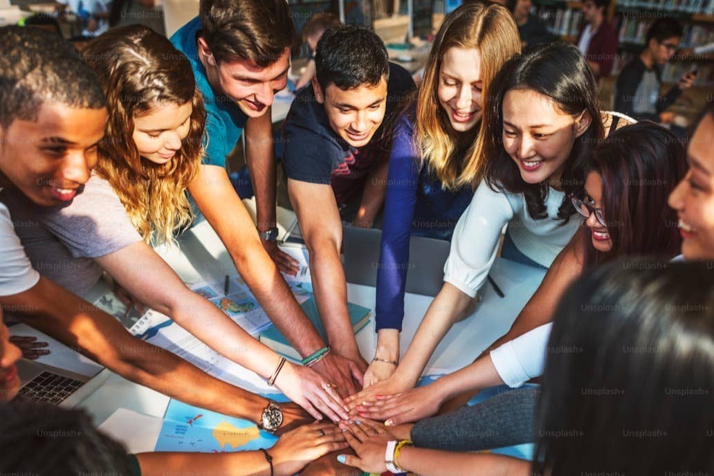A group of people putting their hands in