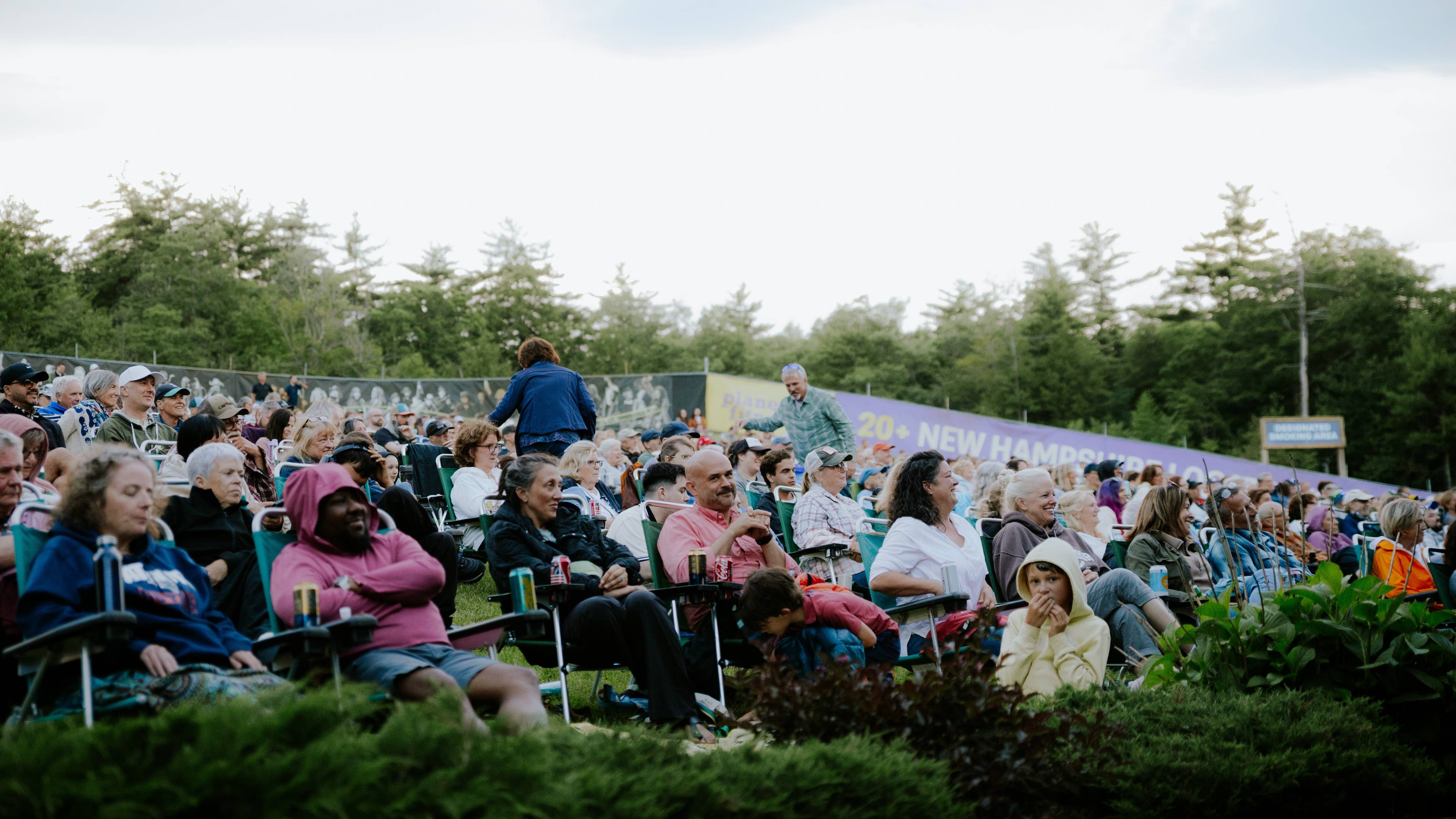 People enjoying a show on their lawnchairs.