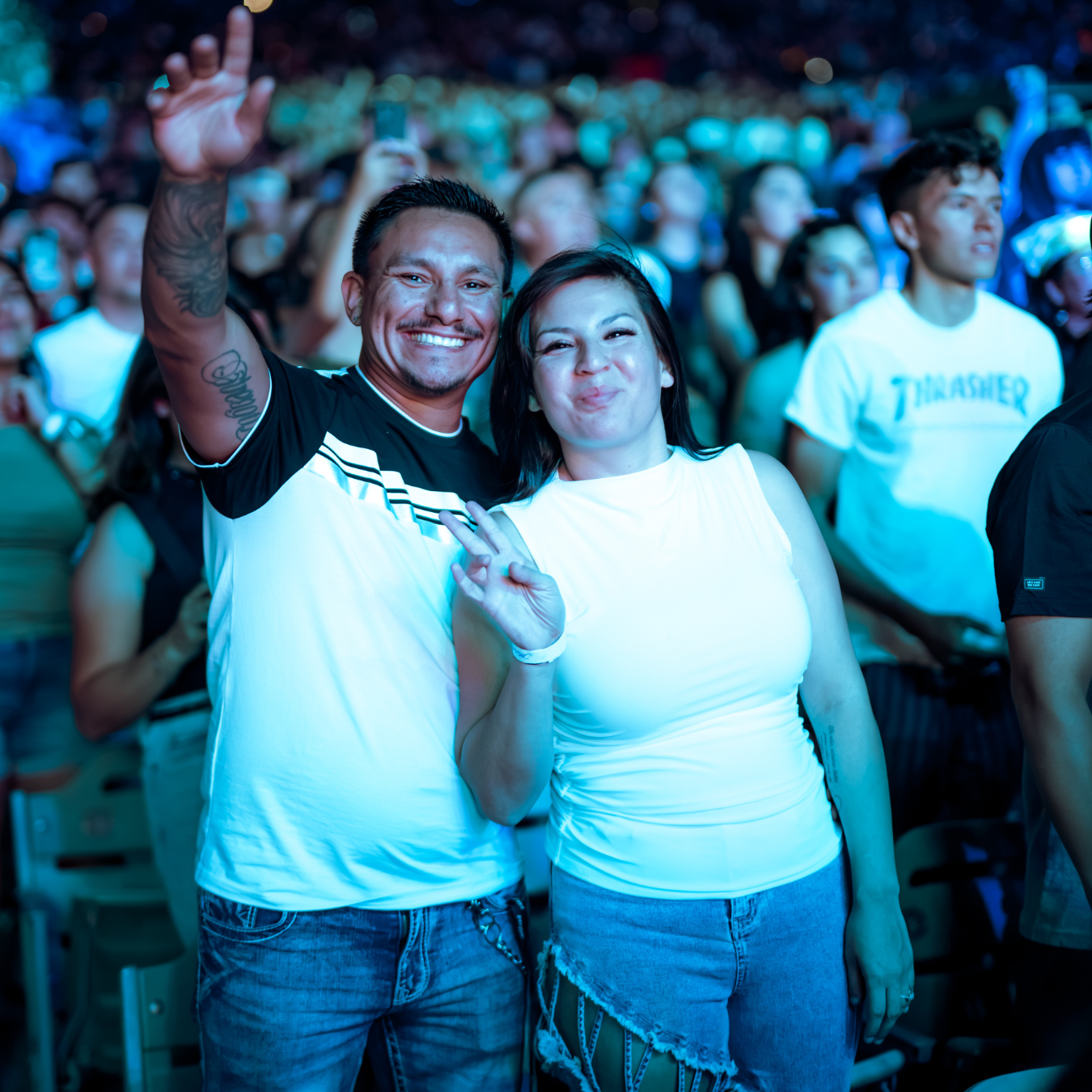 Two people in their seats during the show, smiling