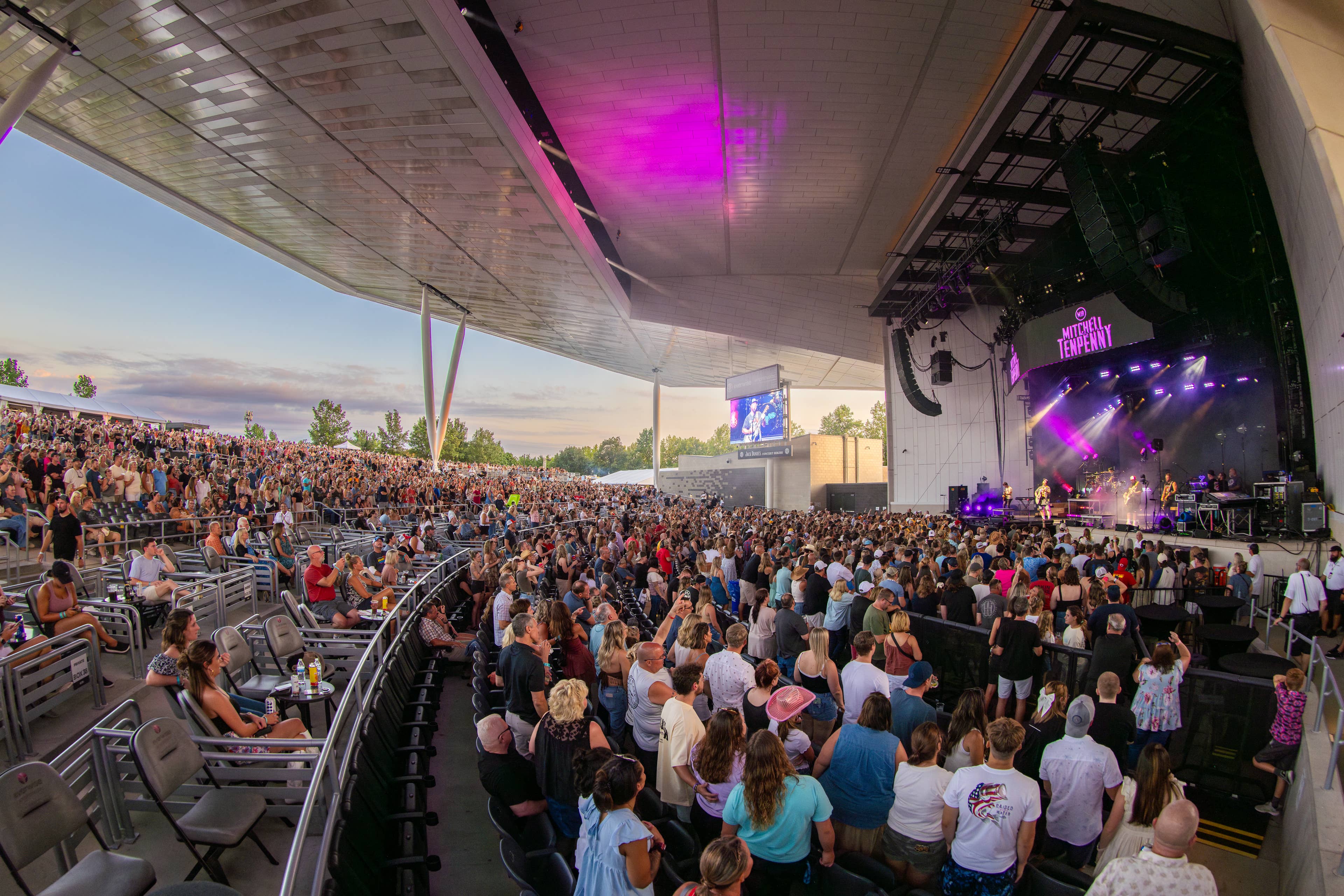 This image shows part of the premium seating area and the rest of the crowd while a concert is happening on stage.

Live Nation presents Jordan Davis at Everwise Amphitheater at White River State Park in Indianapolis, Indiana on July 31, 2024. (Photo by Alive Coverage for Live Nation)
