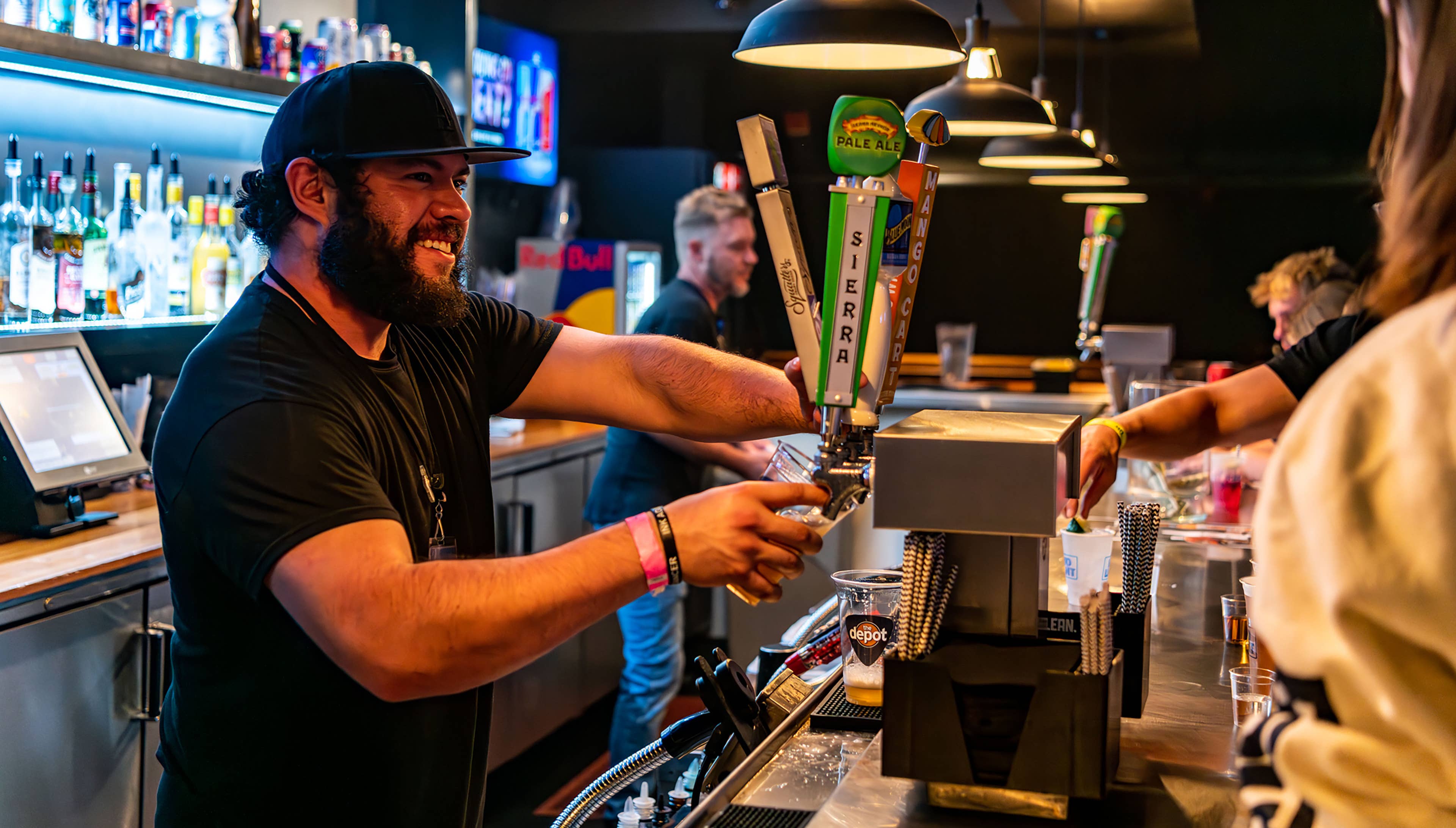 A bartender pours a beer at The Depot
