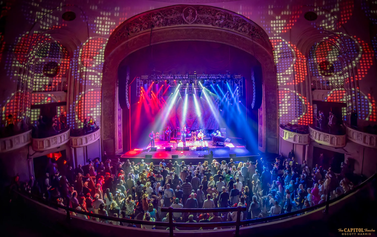 A crowd watching a band play on stage