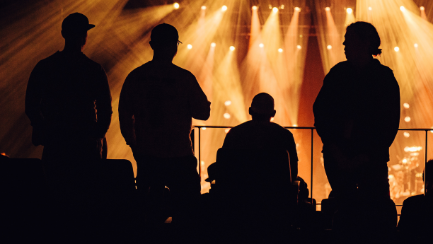 Four fans watching a concert from the accessible seating area.