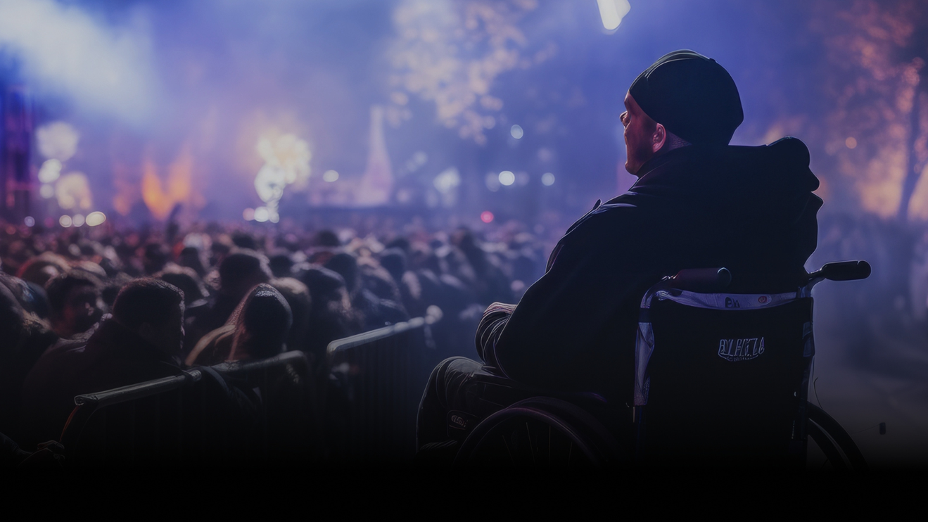 A concertgoer in a wheelchair looks on over the crowd.