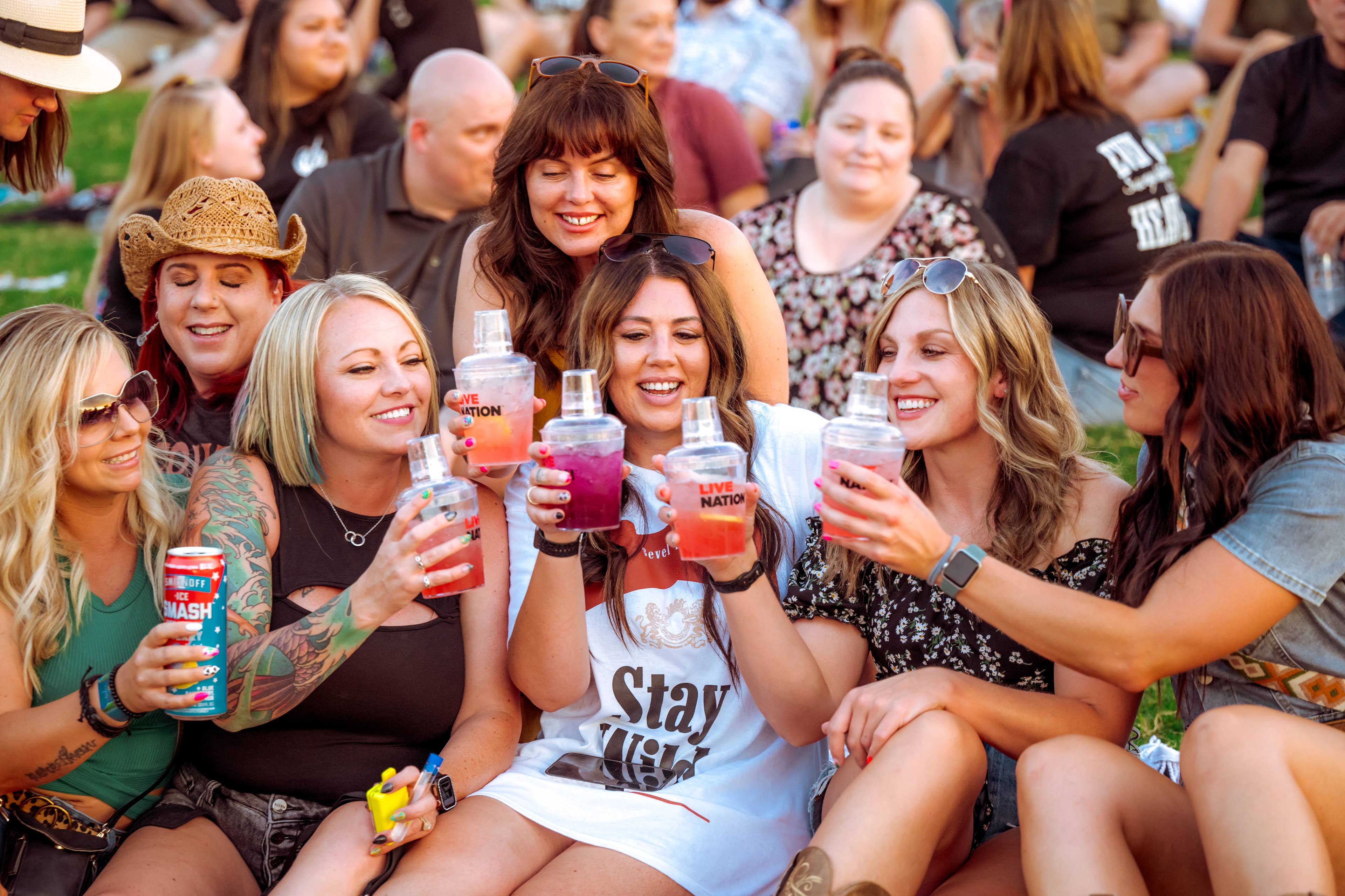 A group of girls sitting drinking cocktails