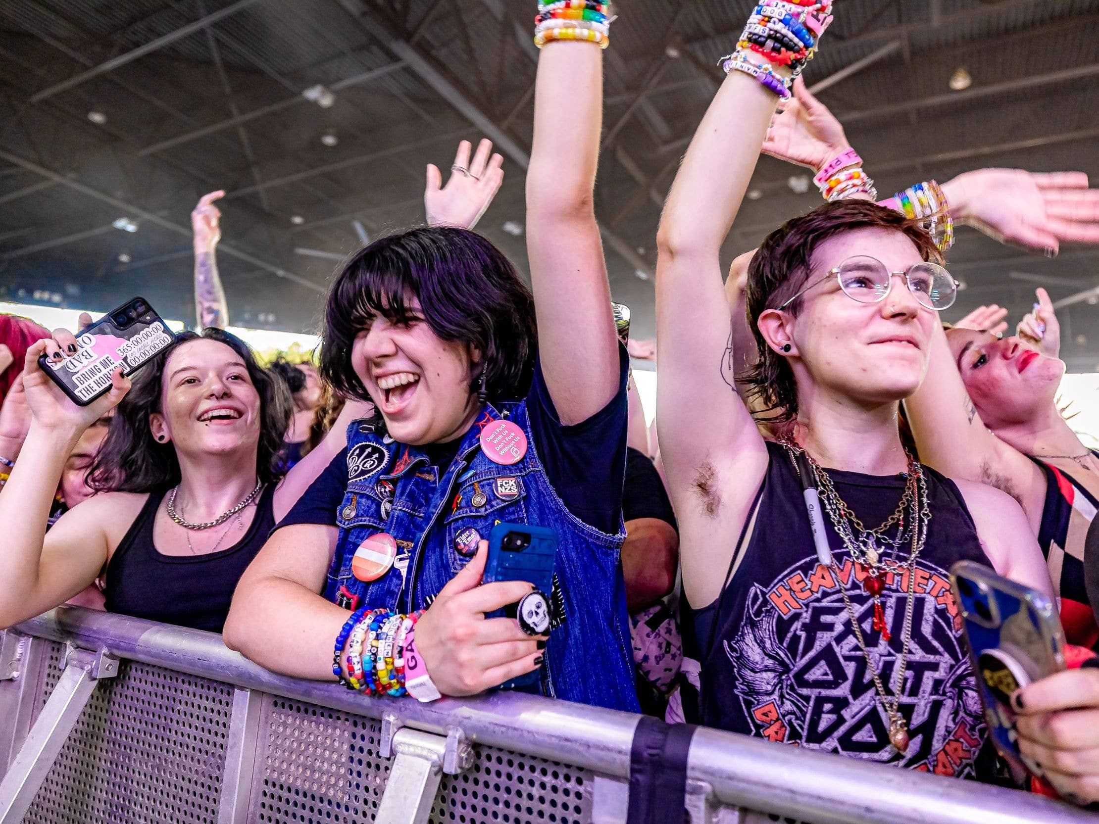 Fans cheering in the first row at a concert
