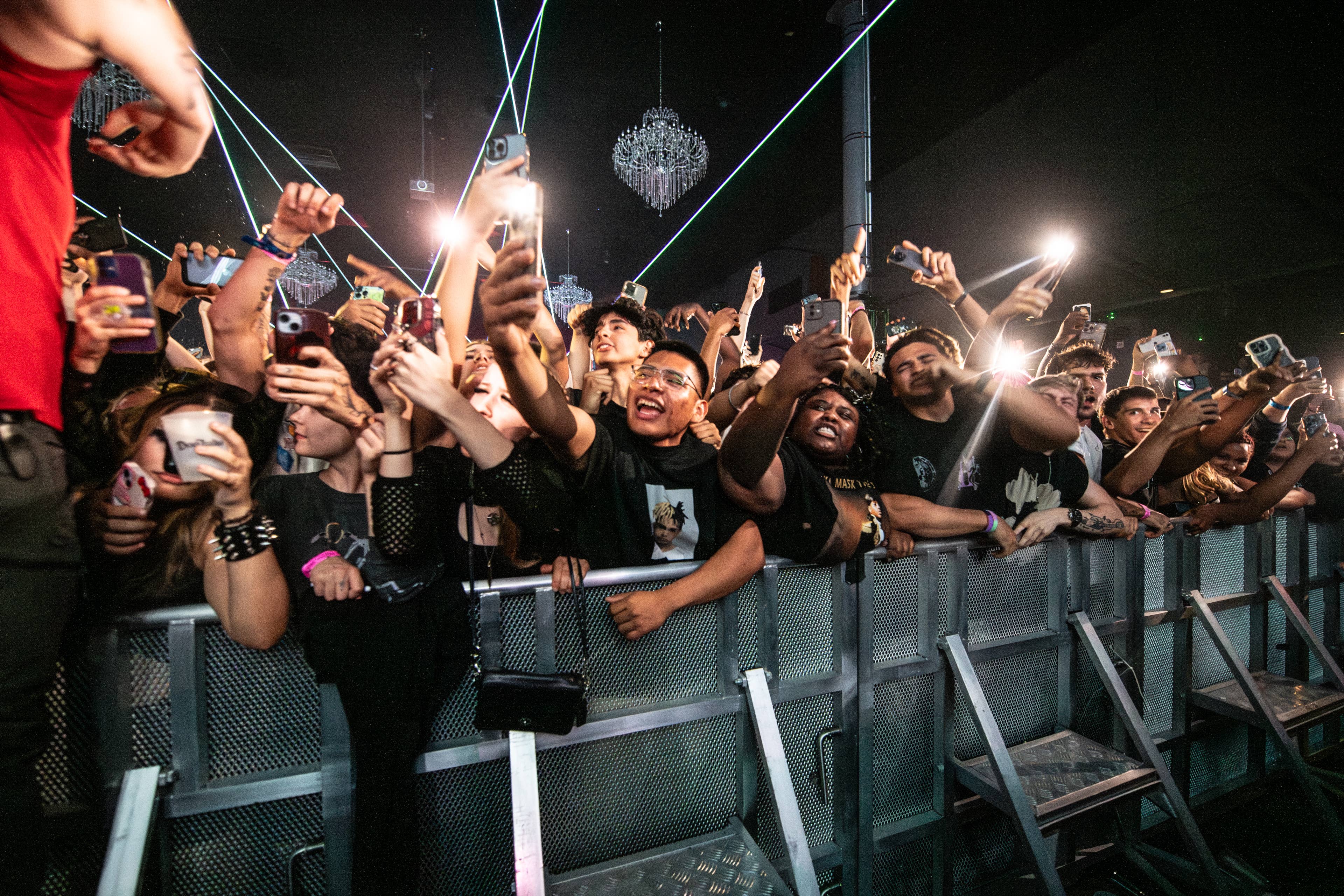 A crowd at an event holding their phones