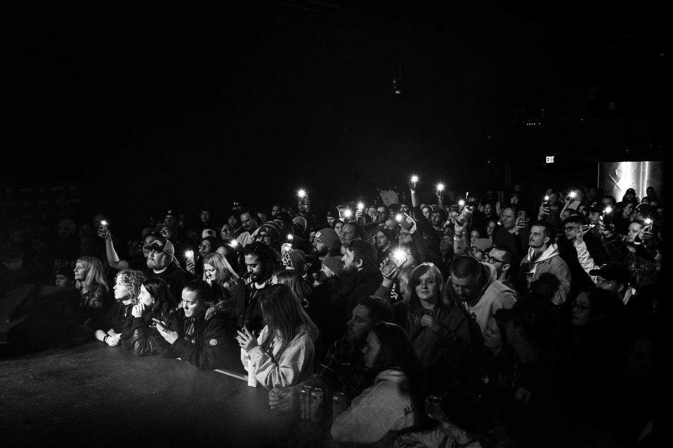 image of crowd pushed up against the stage at the mod club in toronto with flashlights in the air