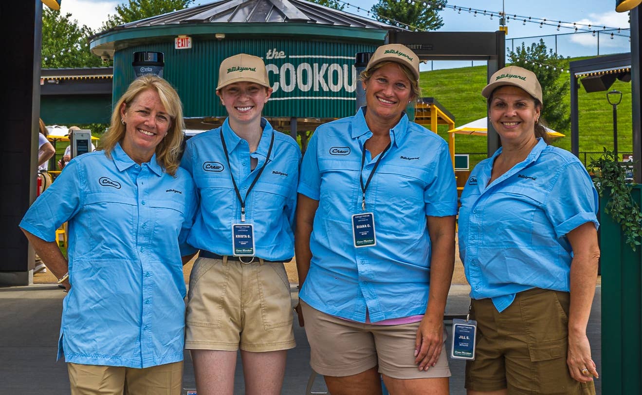Crew Members stand next to each other.