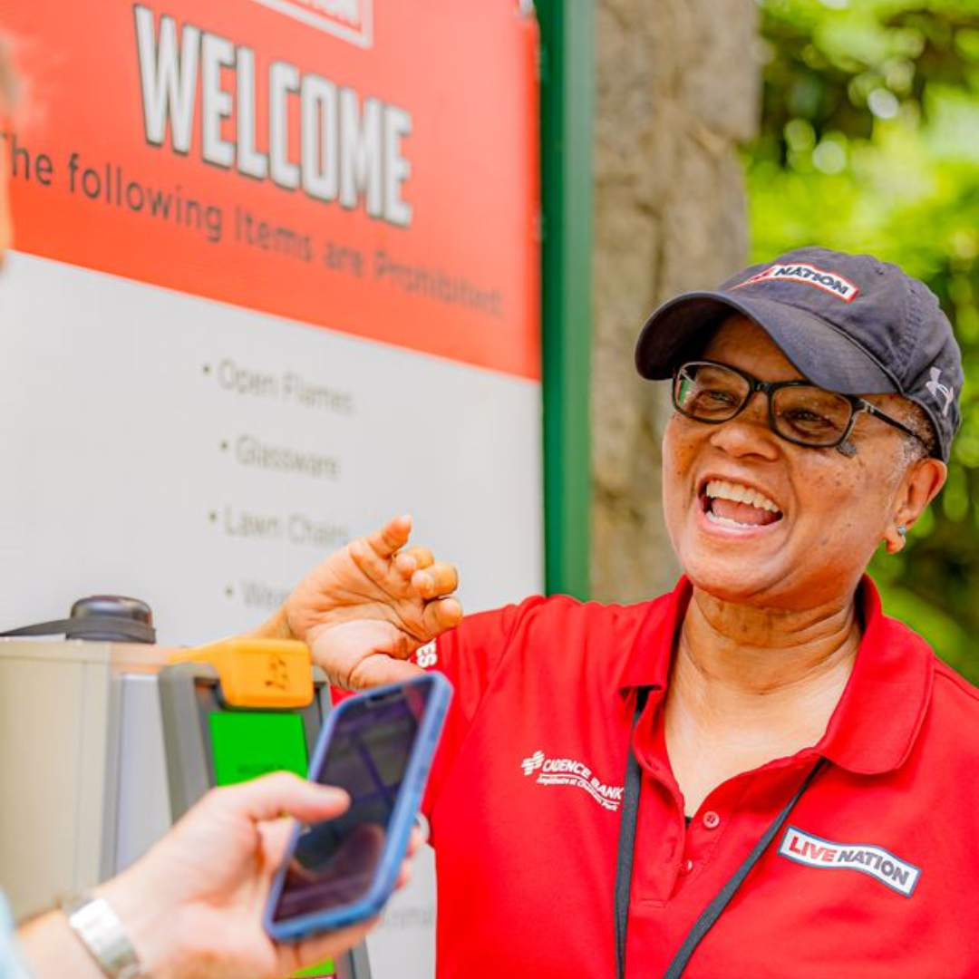 A venue employee scanning the ticket of a fan.