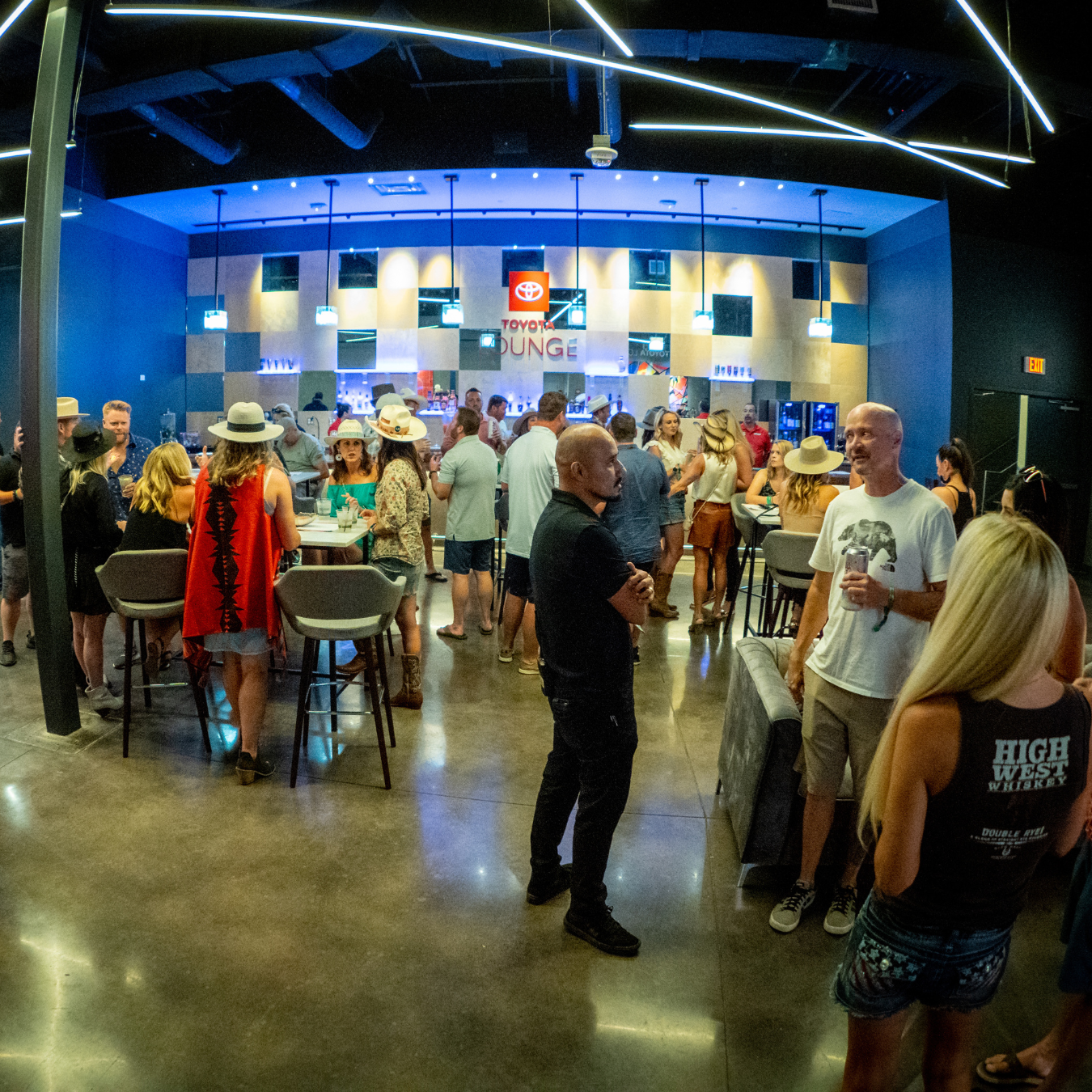 People hanging around in the VIP Club area which has a bar