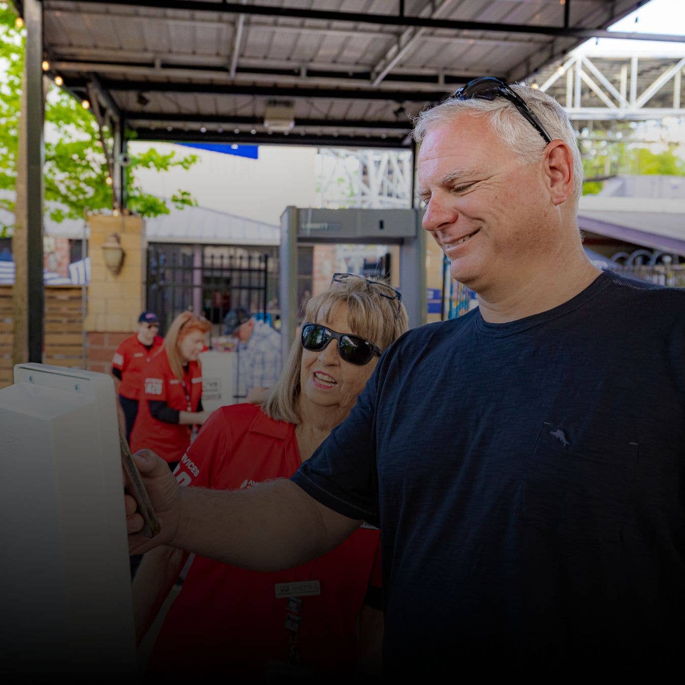 A fan entering the venue through a premium entry gate