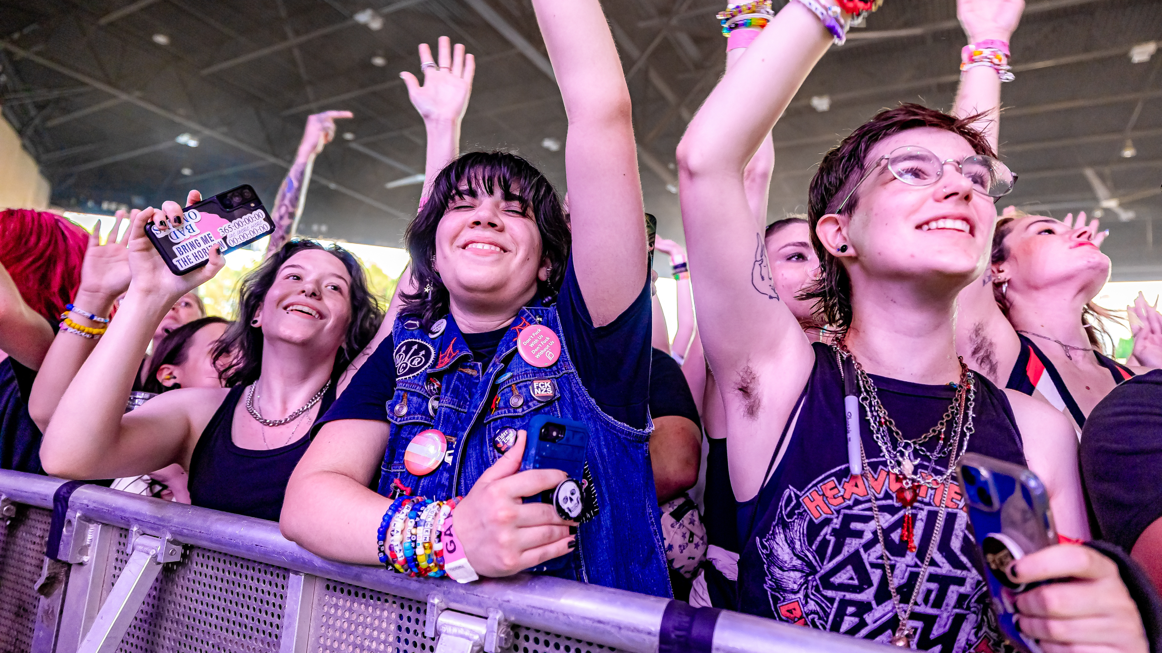 Fans enjoying a live concert from the front-of-stage pit area