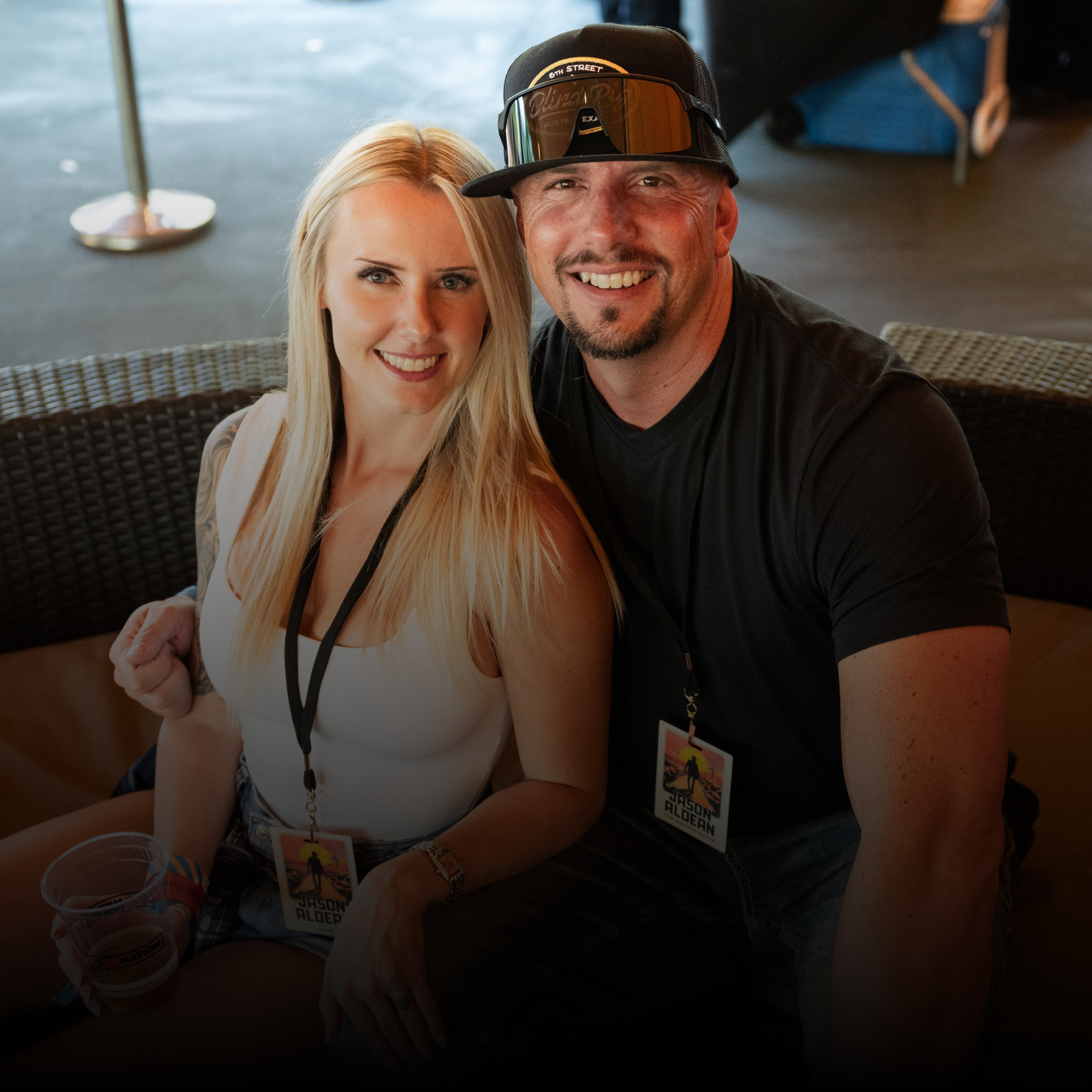 A couple sitting in the VIP area smiling at the camera