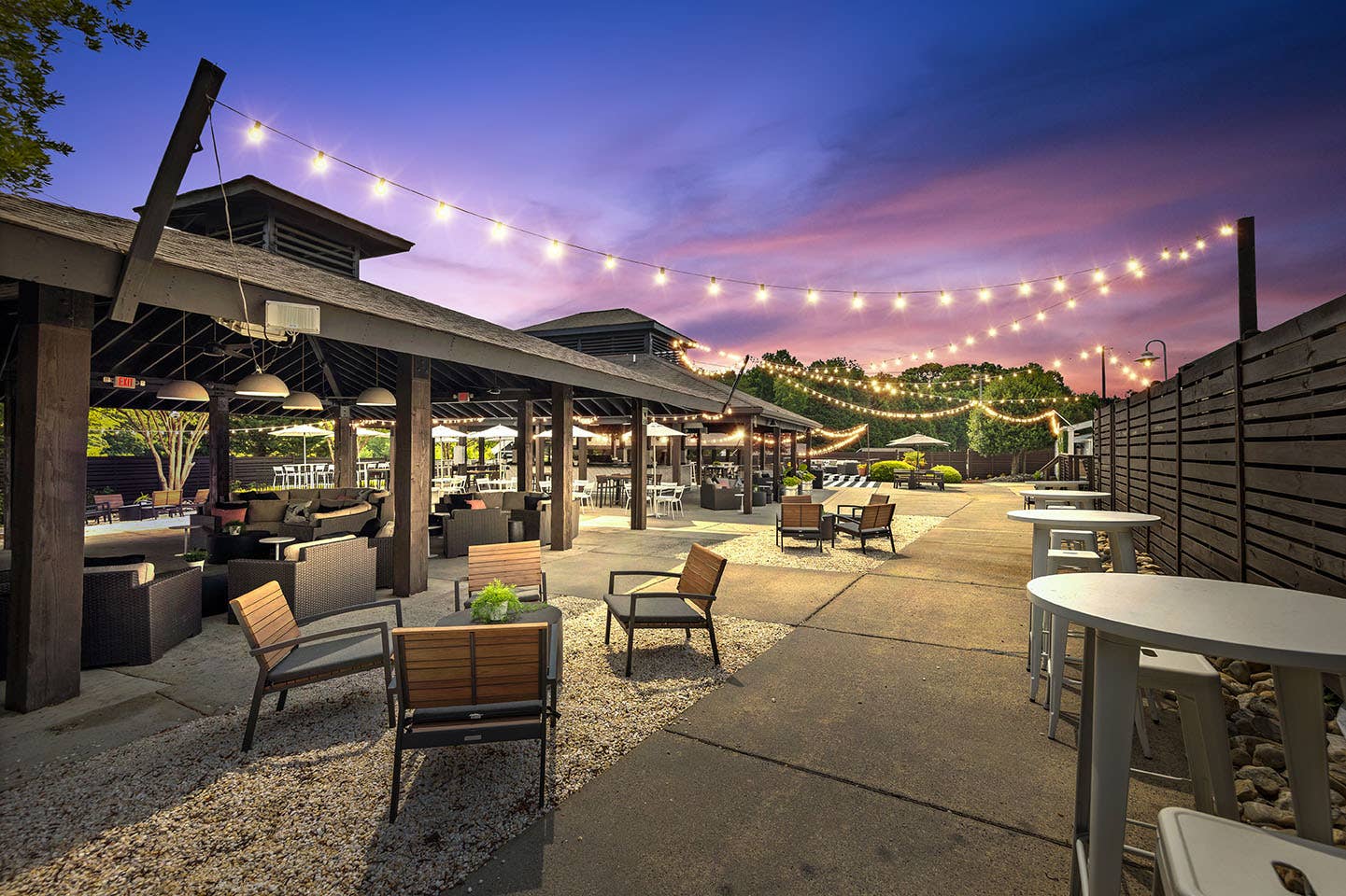 The outdoor Truliant VIP Club area at night with string lights at Truliant Amphitheater.