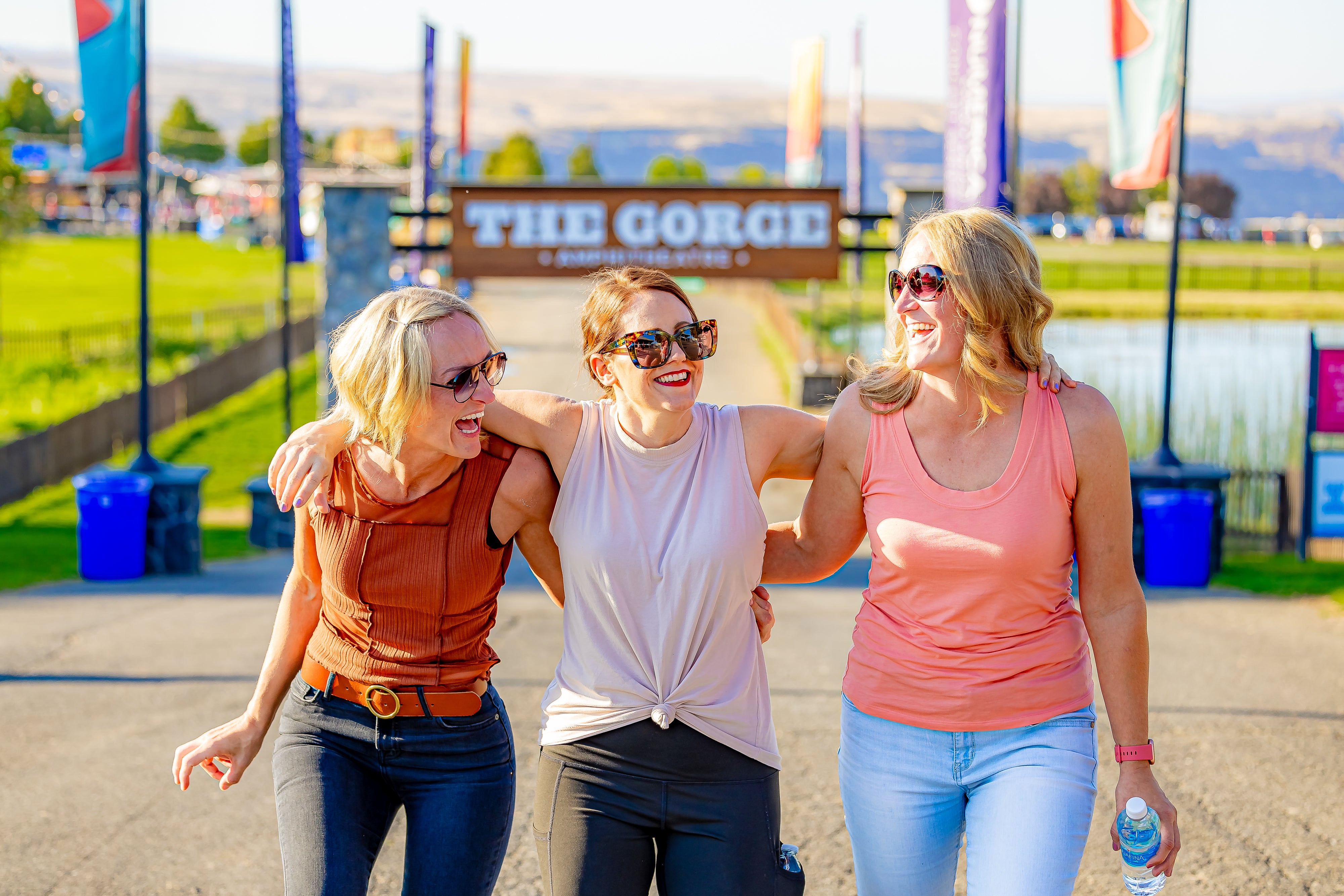 The friends walking together with the gorge sign behind them 