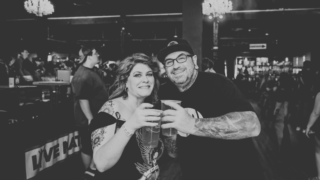 A photo of a couple cheers their drinks at The Fillmore Charlotte.