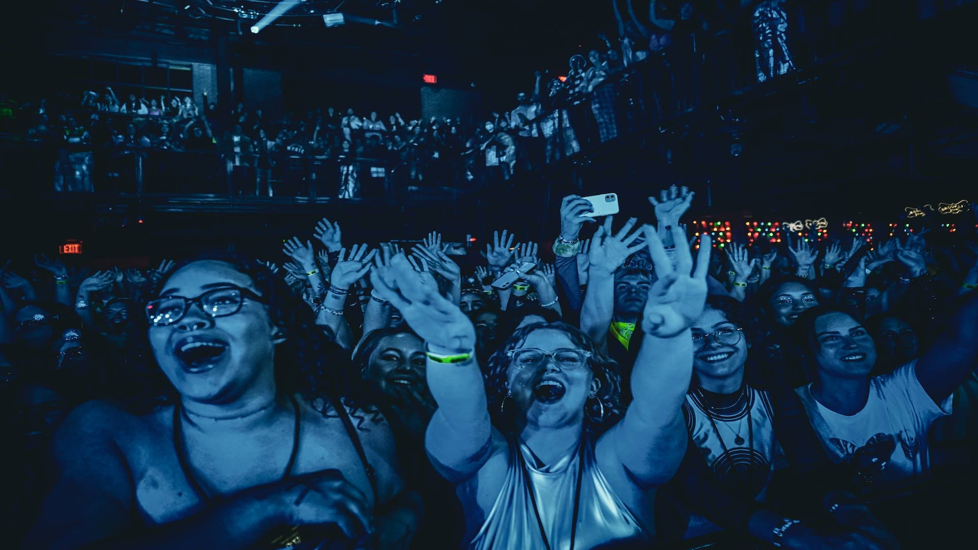 A view of the fans with their hand in the air