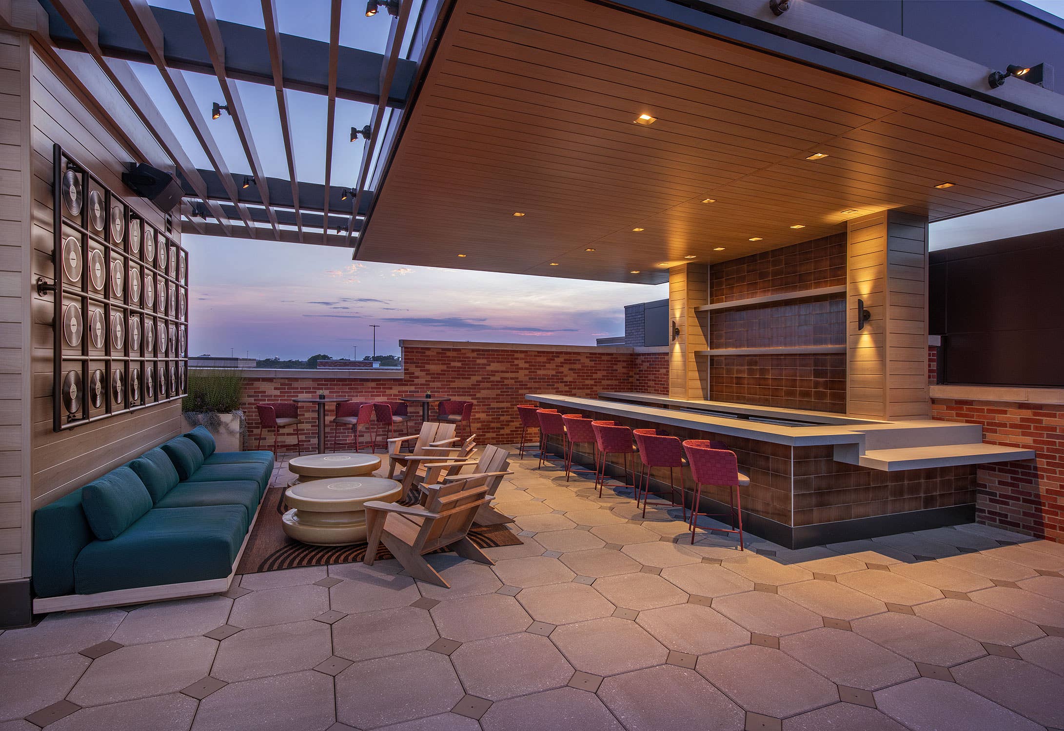 A VIP Club area with couches and high top chairs near an outdoor bar 