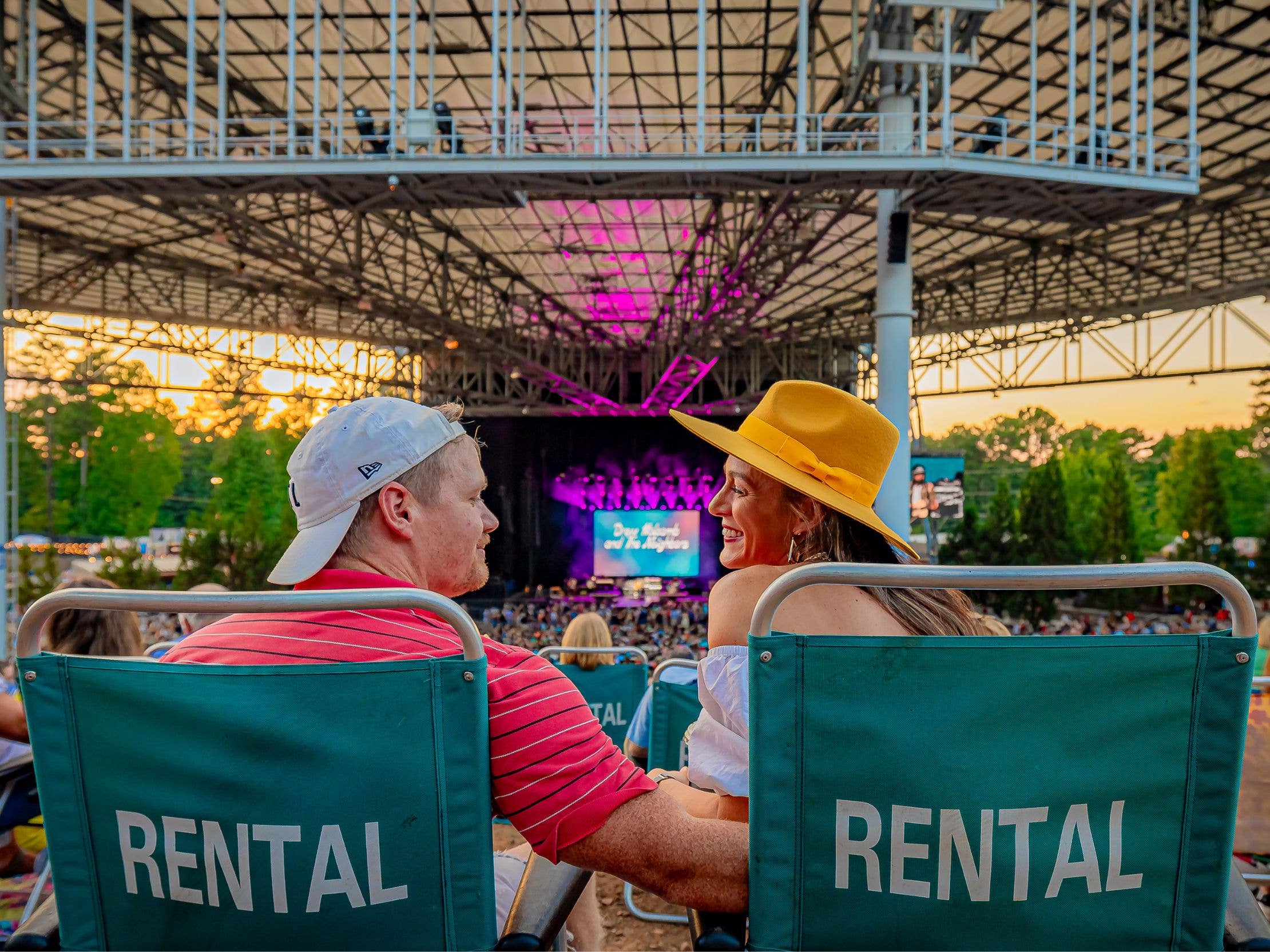 Two people sitting on rental chairs