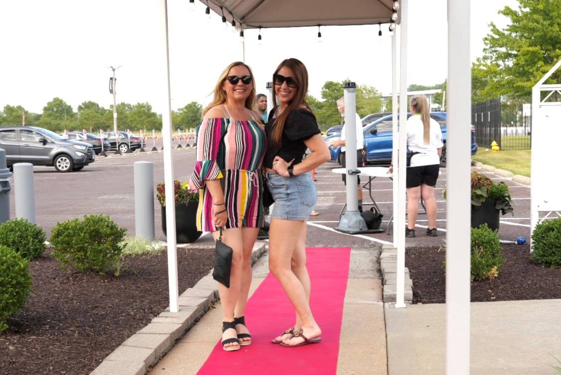 Two fans pose as they enter the Premium Entrance at the amphitheater.