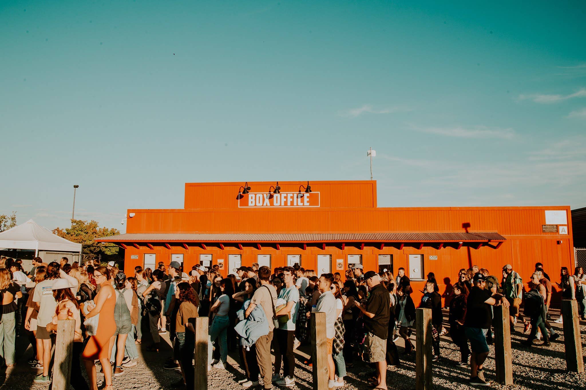 A photo of the box office with fans waiting in front 