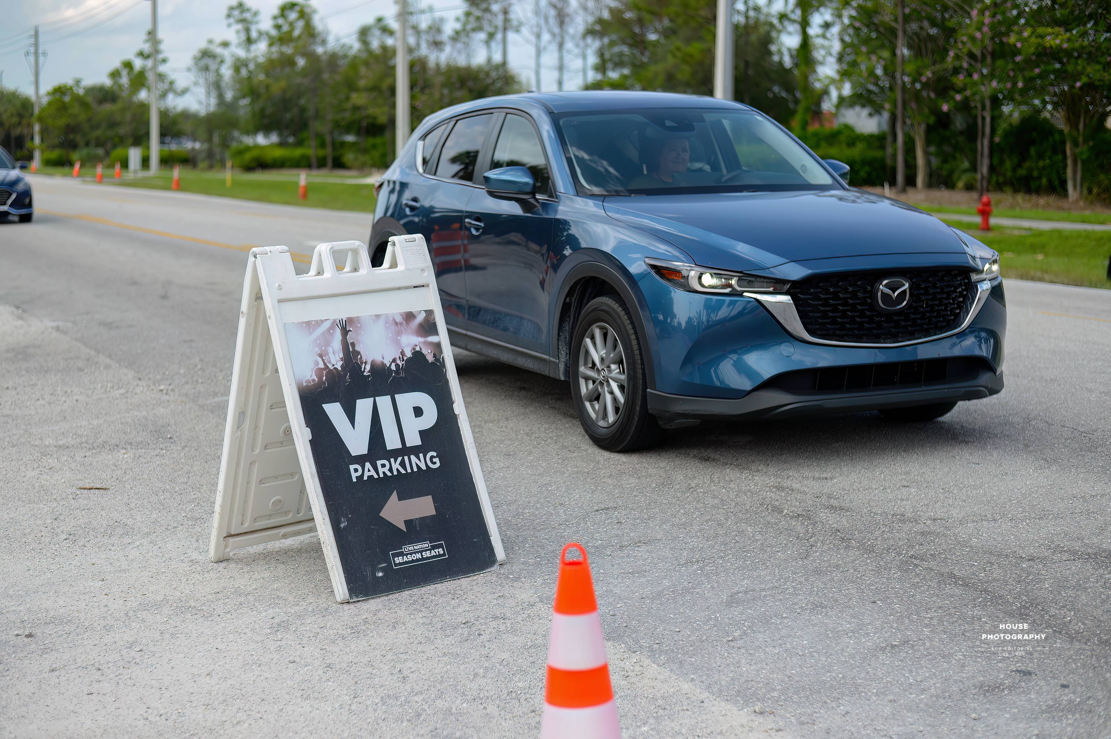 A blue car pulling up to the VIP Parking entrance