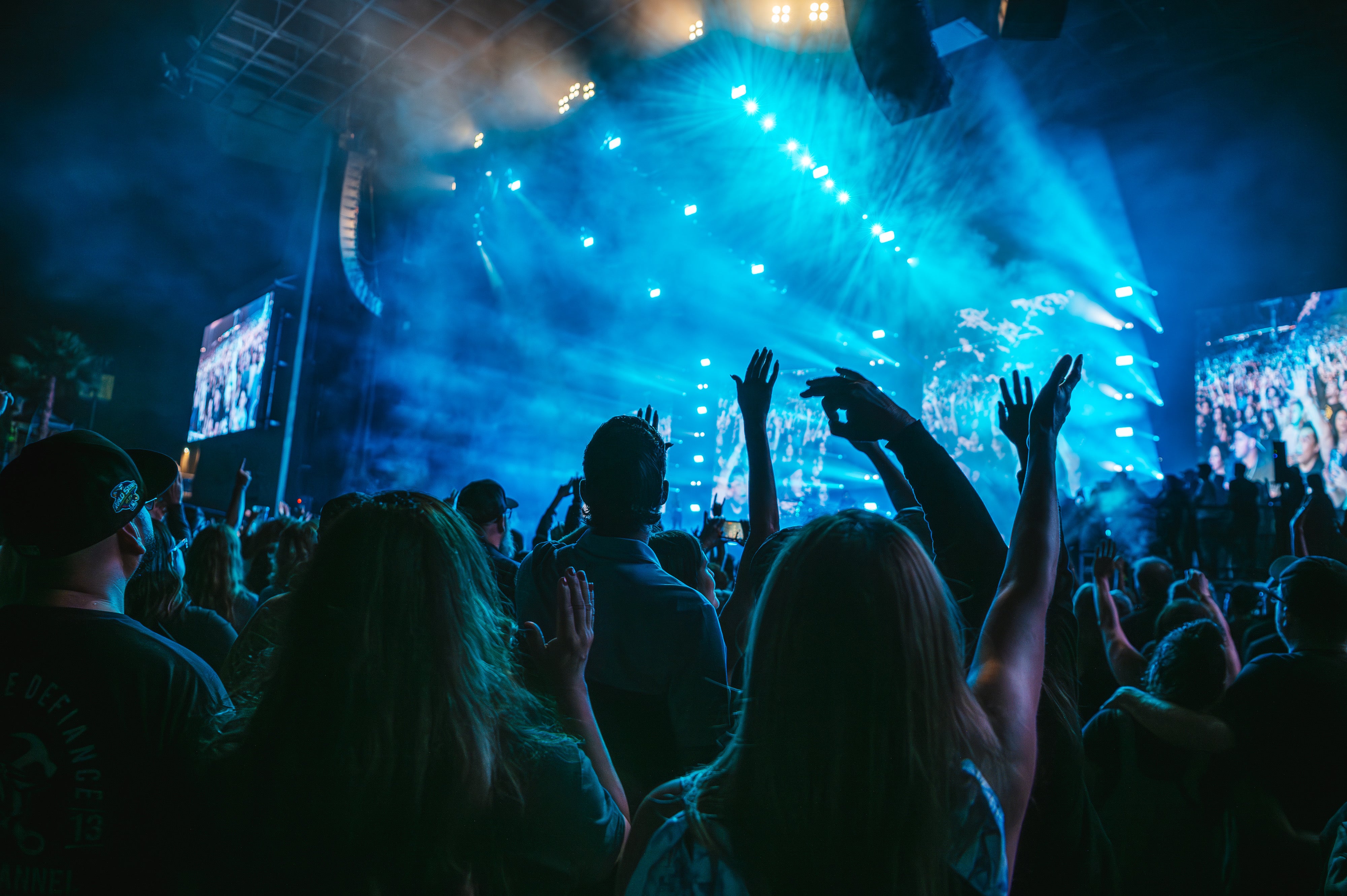 Fans Watching a Show With Hands Up