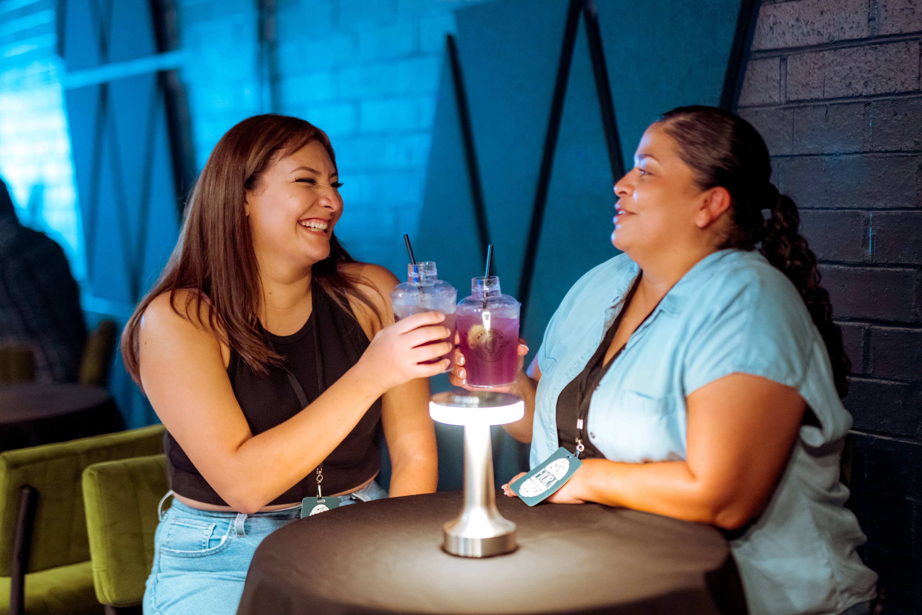 Two woman cheersing their drinks in the Flora Lounge.