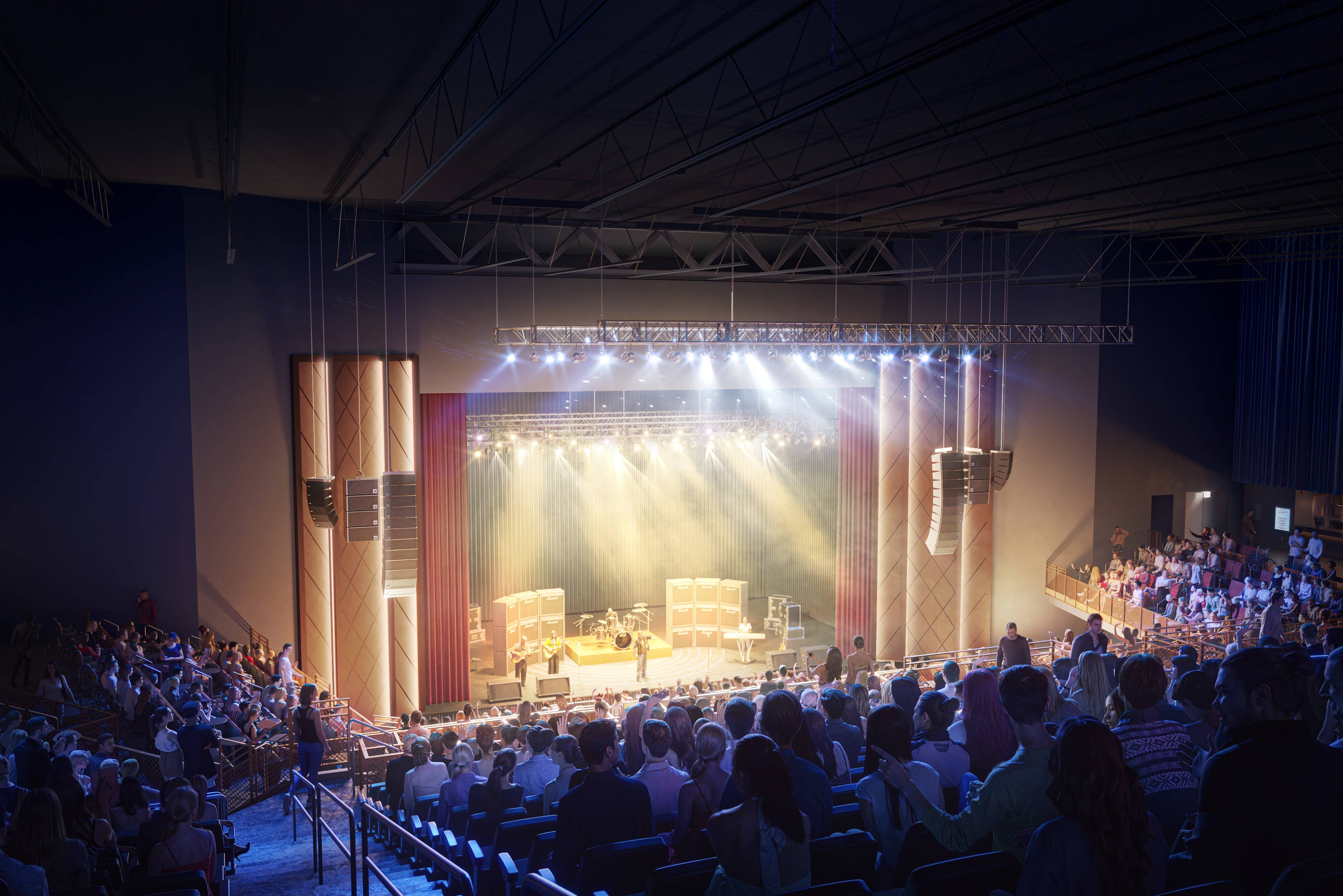 A view of an audience members sitting on the left side of the seating area facing the stage