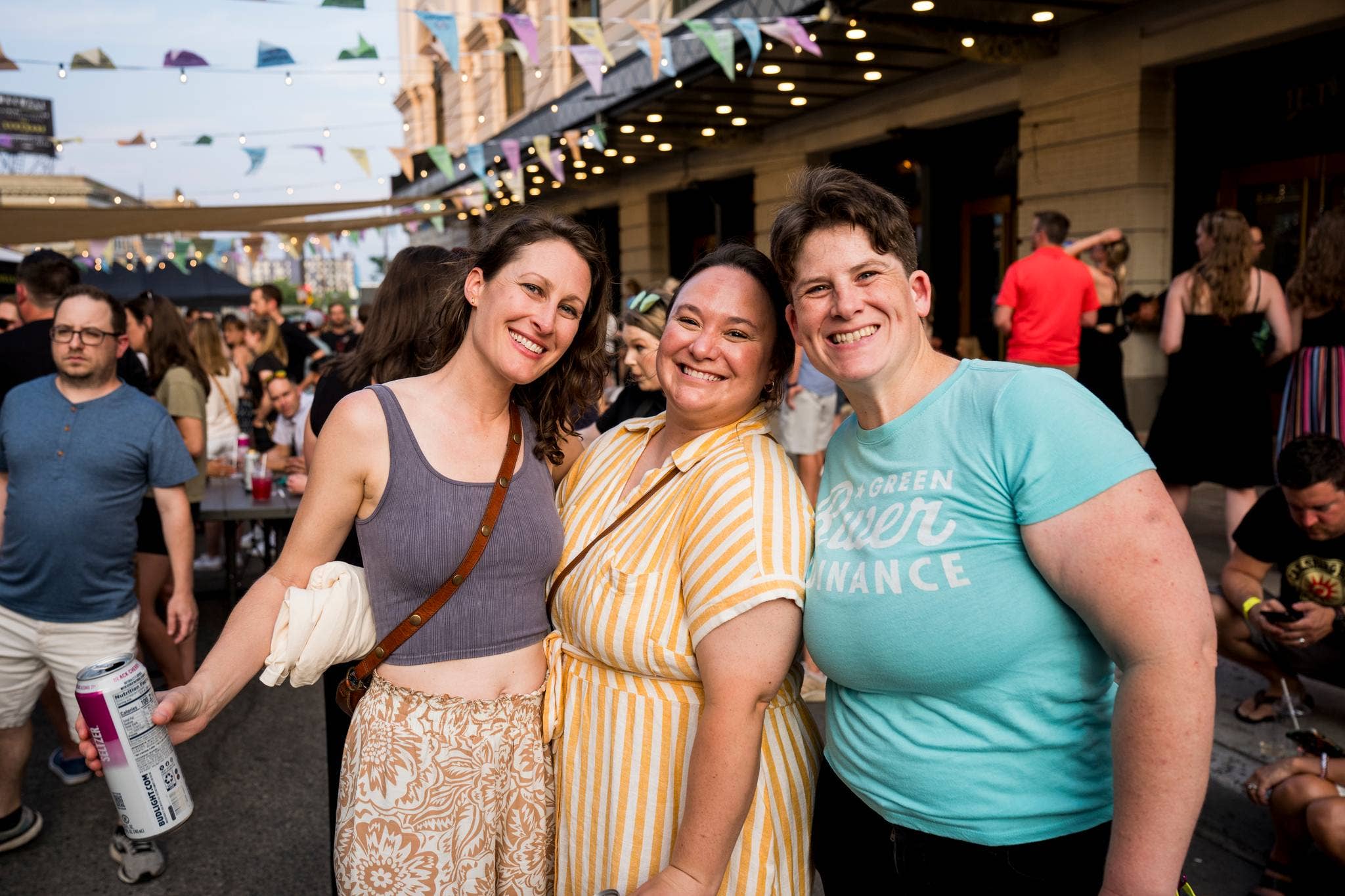 three people smiling and facing the camera