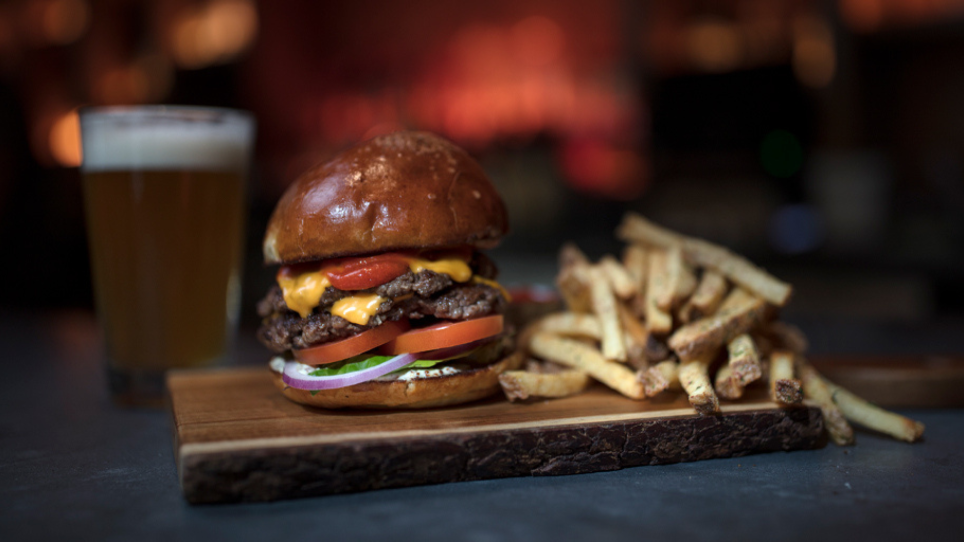 A burger, beer, and French fries that are served at Trax Burgers and Bar