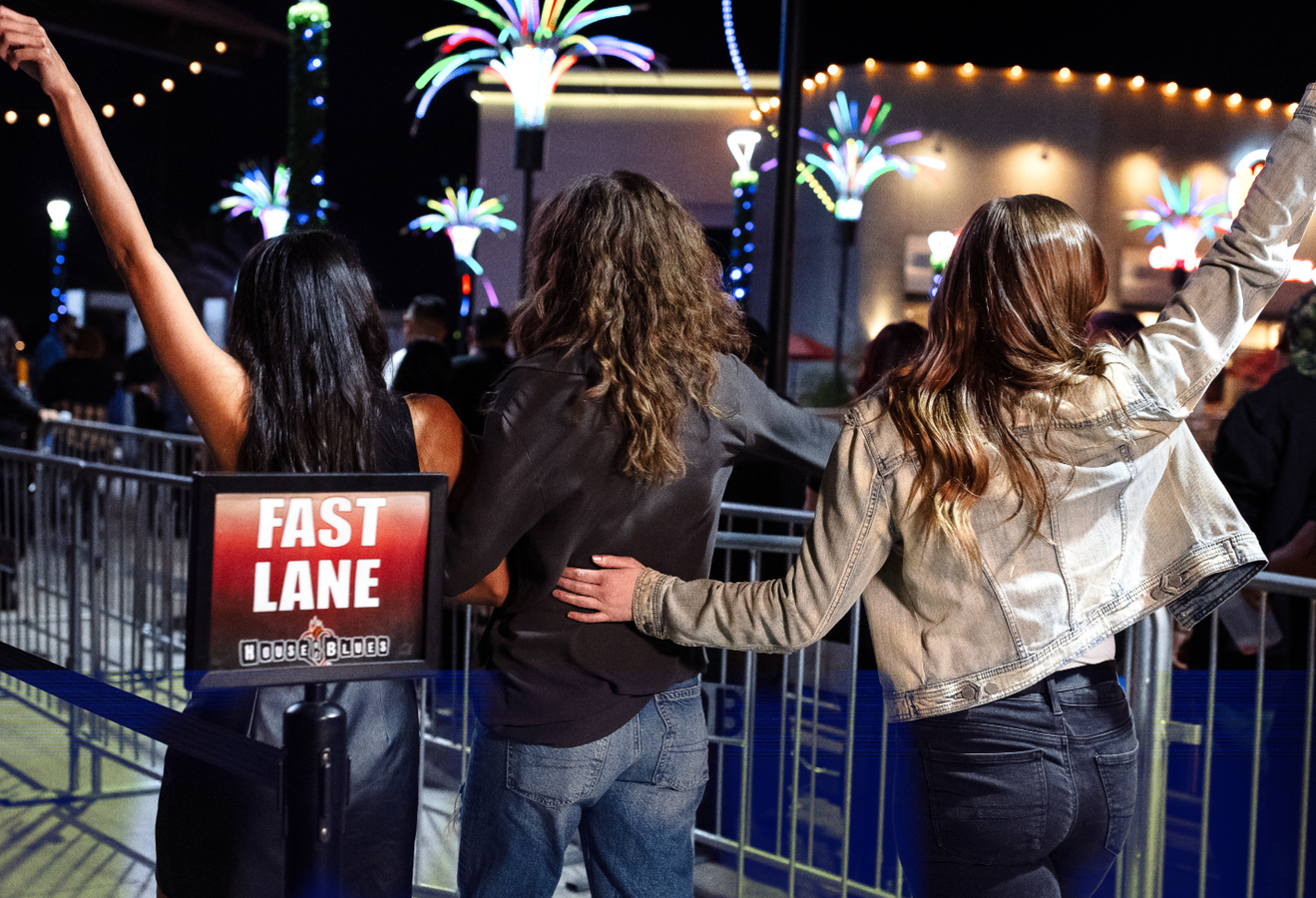 Three people walking through the fast lane entrance