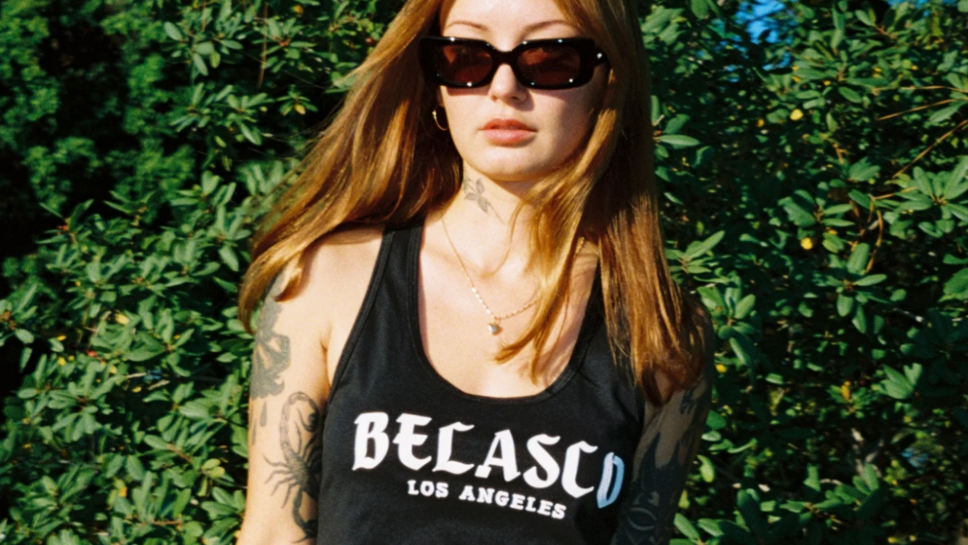 A woman wearing Belasco merch