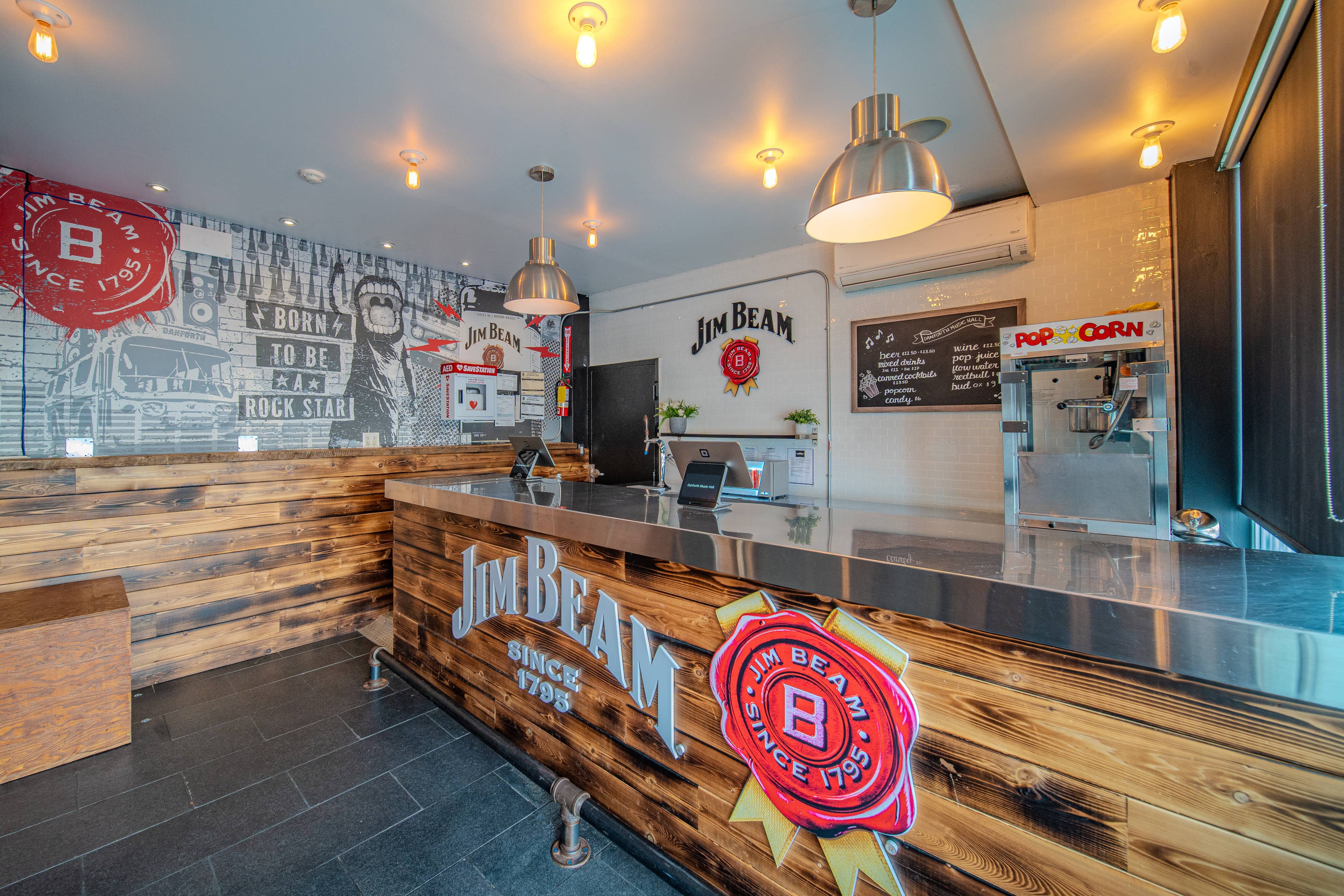 view of a brightly lit bar at Danforth Music Hall in Toronto with a popcorn machine
