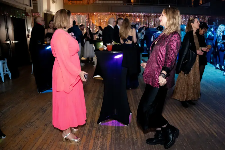 a photo of a private event at Warsaw Concerts featuring a crowd of people wearing formal attire dancing and conversing in Warsaw's main ballroom