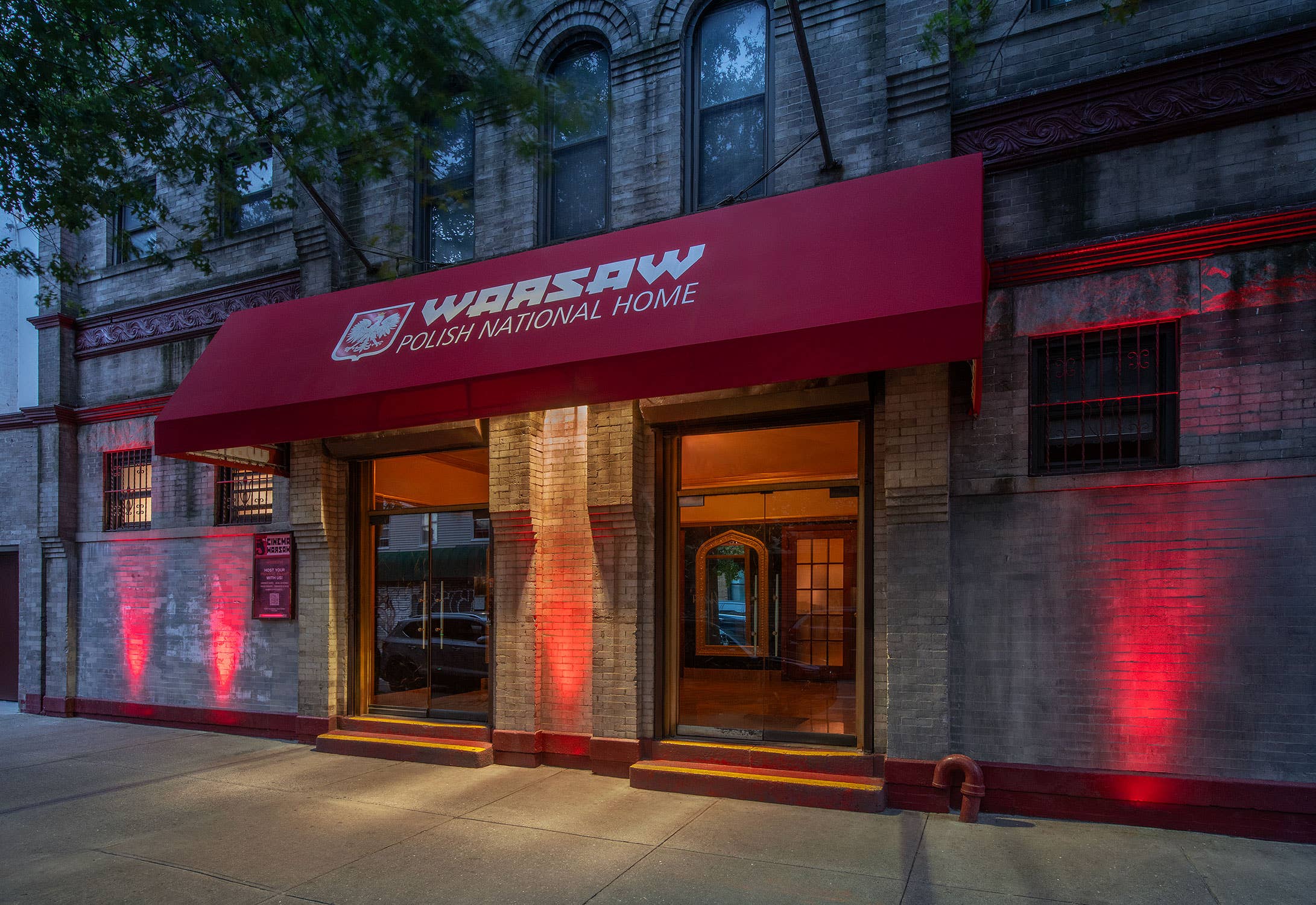 a photo of Warsaw's main entrance which features a red awning that says Warsaw Polish National Home above the double doors