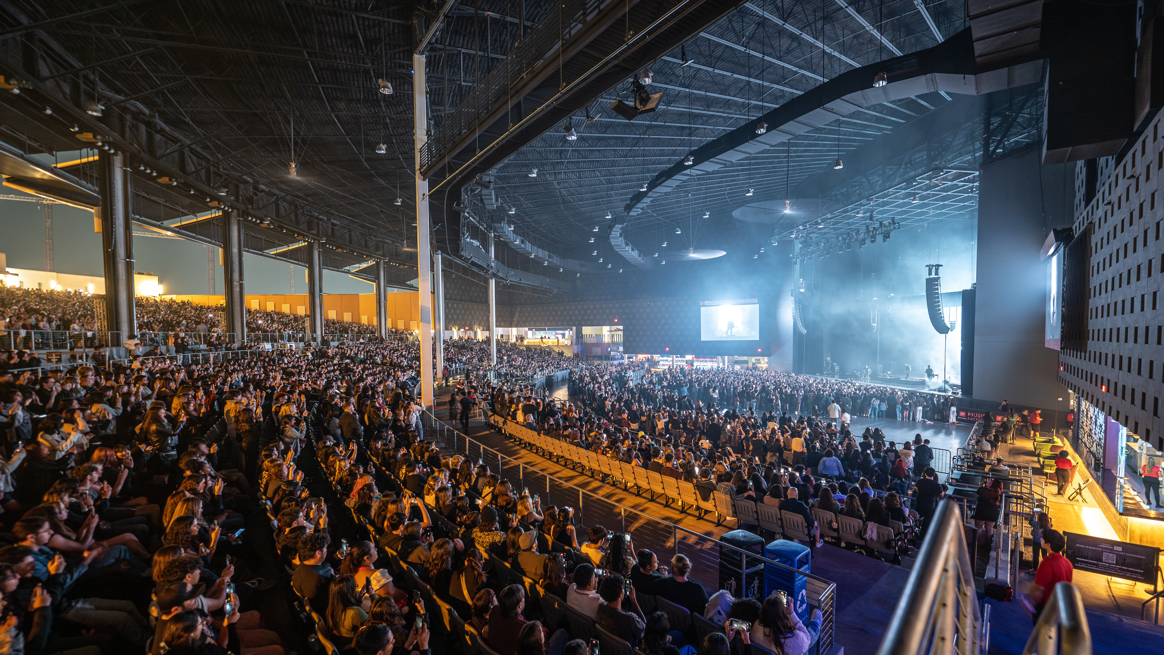 An overlook of The Pavilion at Toyota Music Factory during a performance, with the lawn open.