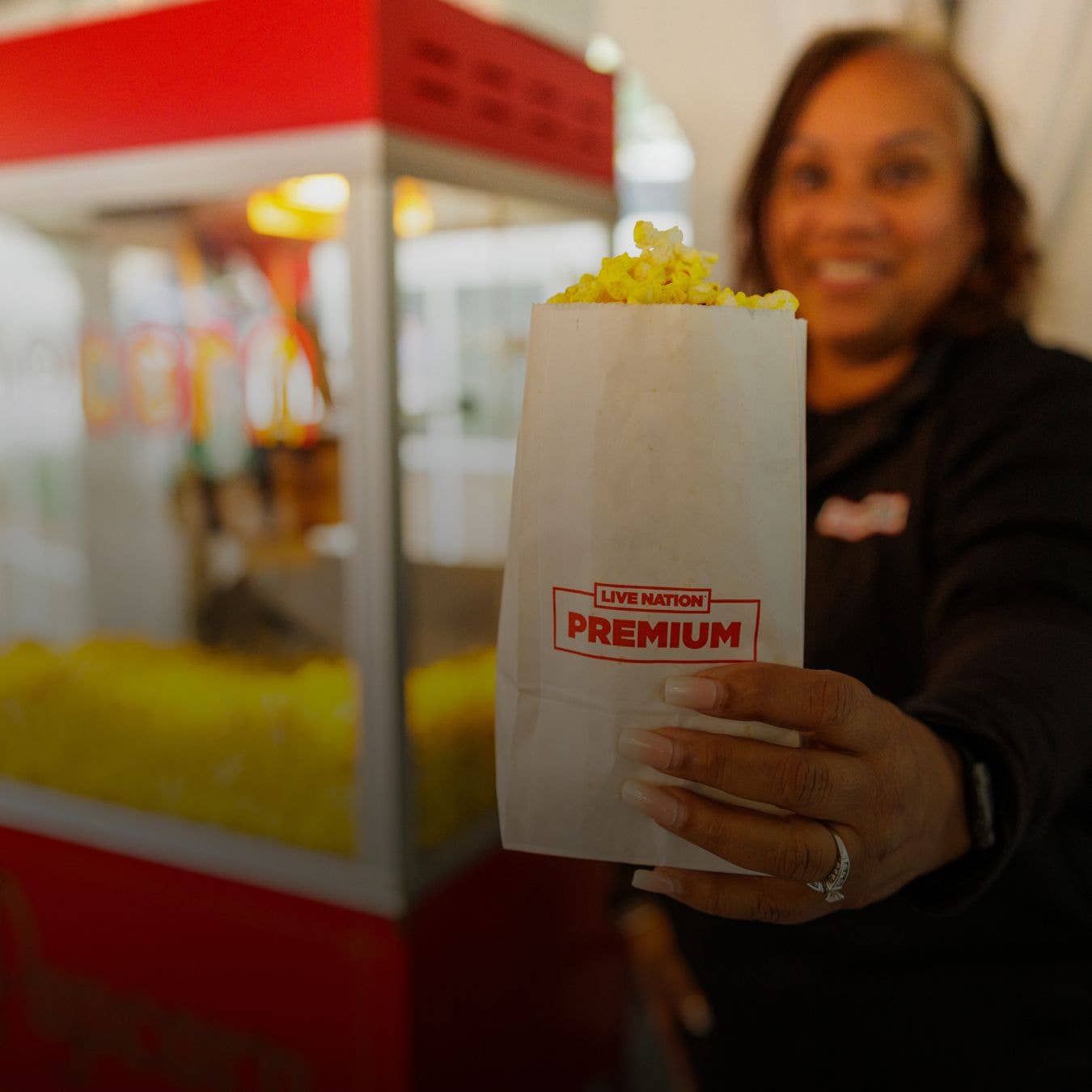 A picture of a women holding up popcorn.