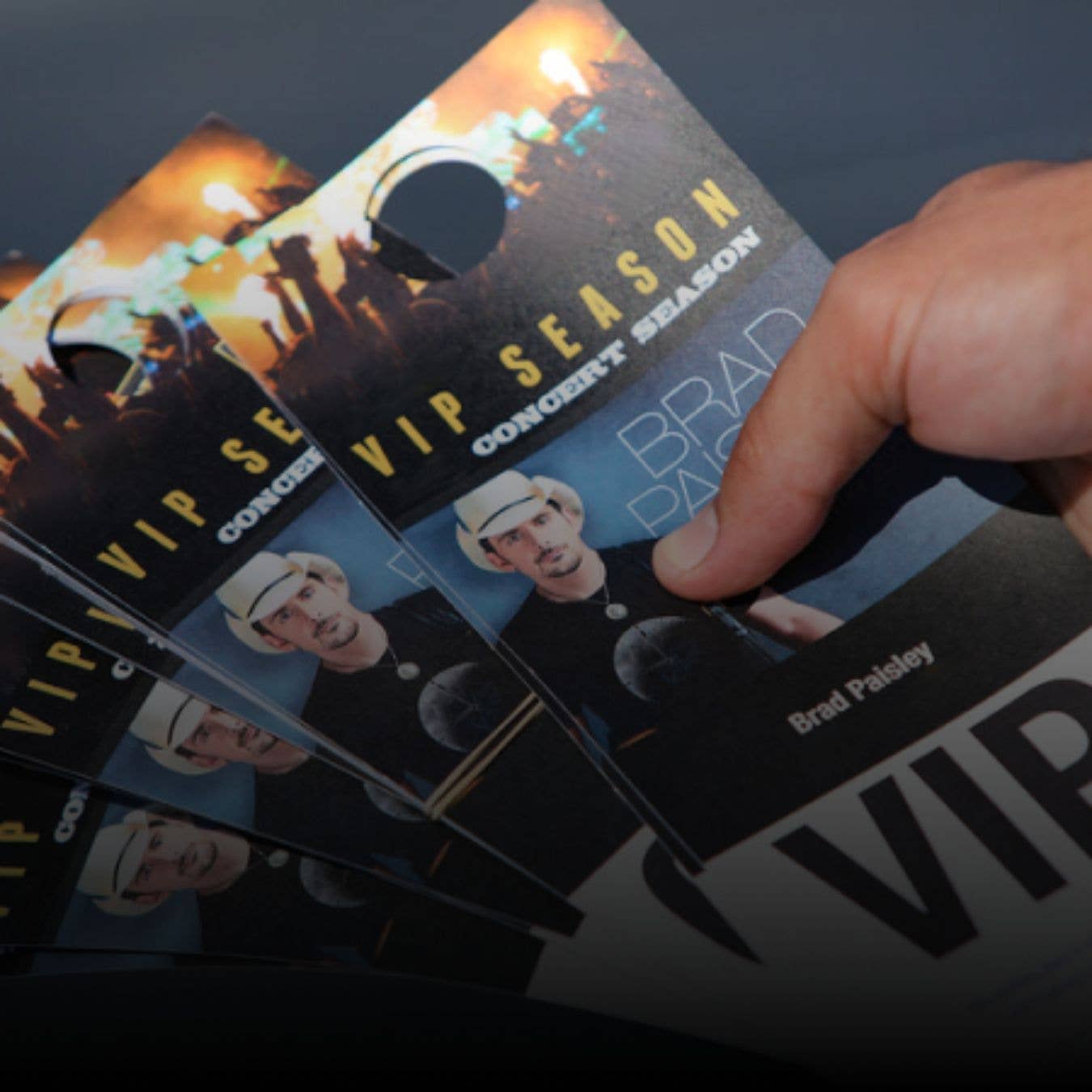Close up photo of Brad Paisley multiple VIP passes